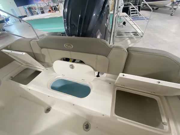 2024 Key West 203 FS boat interior with storage compartments and seating.