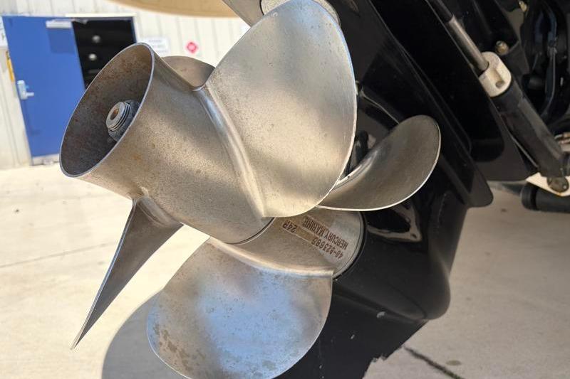 Close-up of a 2007 Sea Ray 240 Sundeck boat propeller in a sunny outdoor setting.