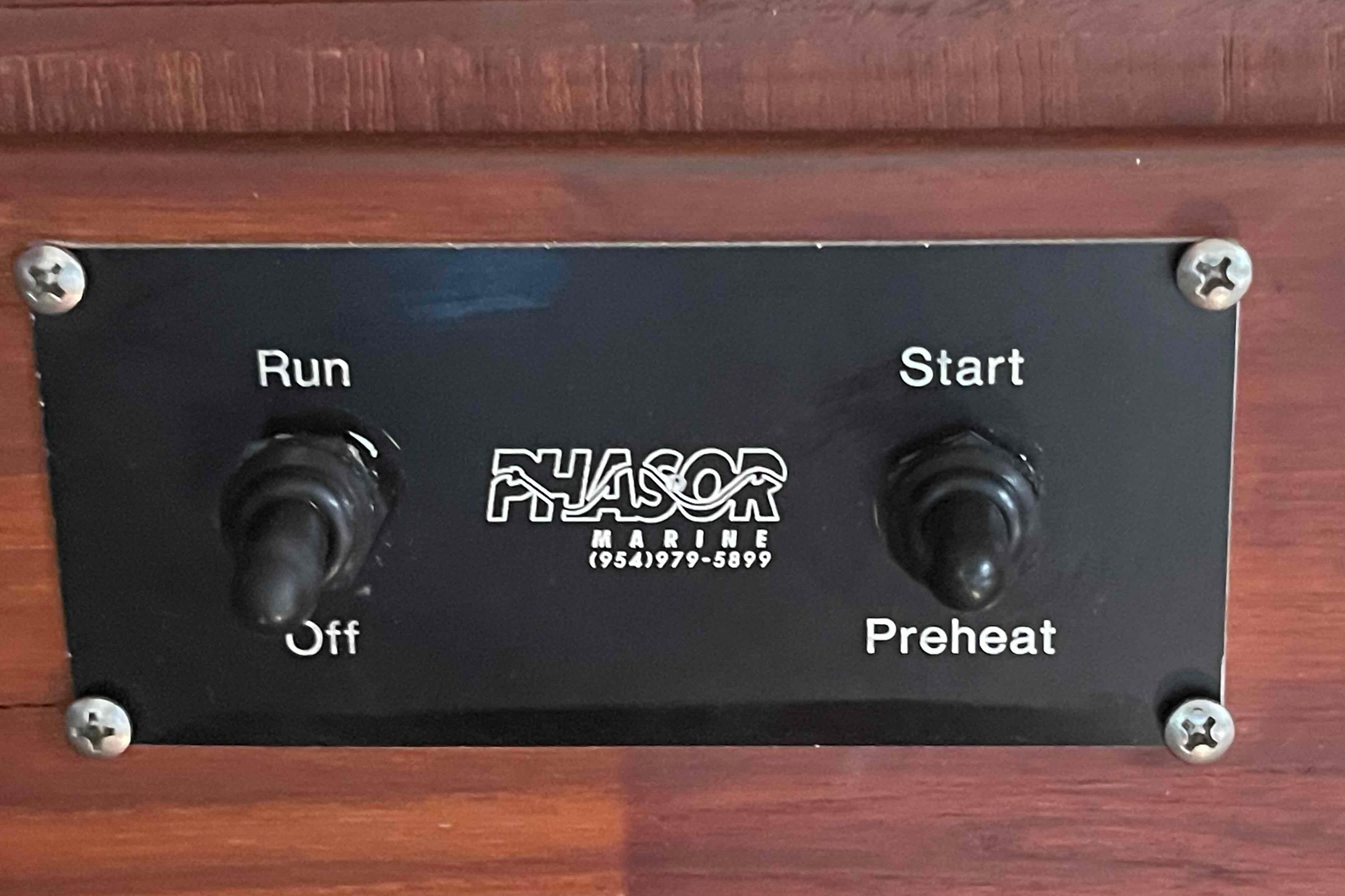 Control panel with switches for "Run," "Off," "Start," and "Preheat" on Island Packet 35, 1989.
