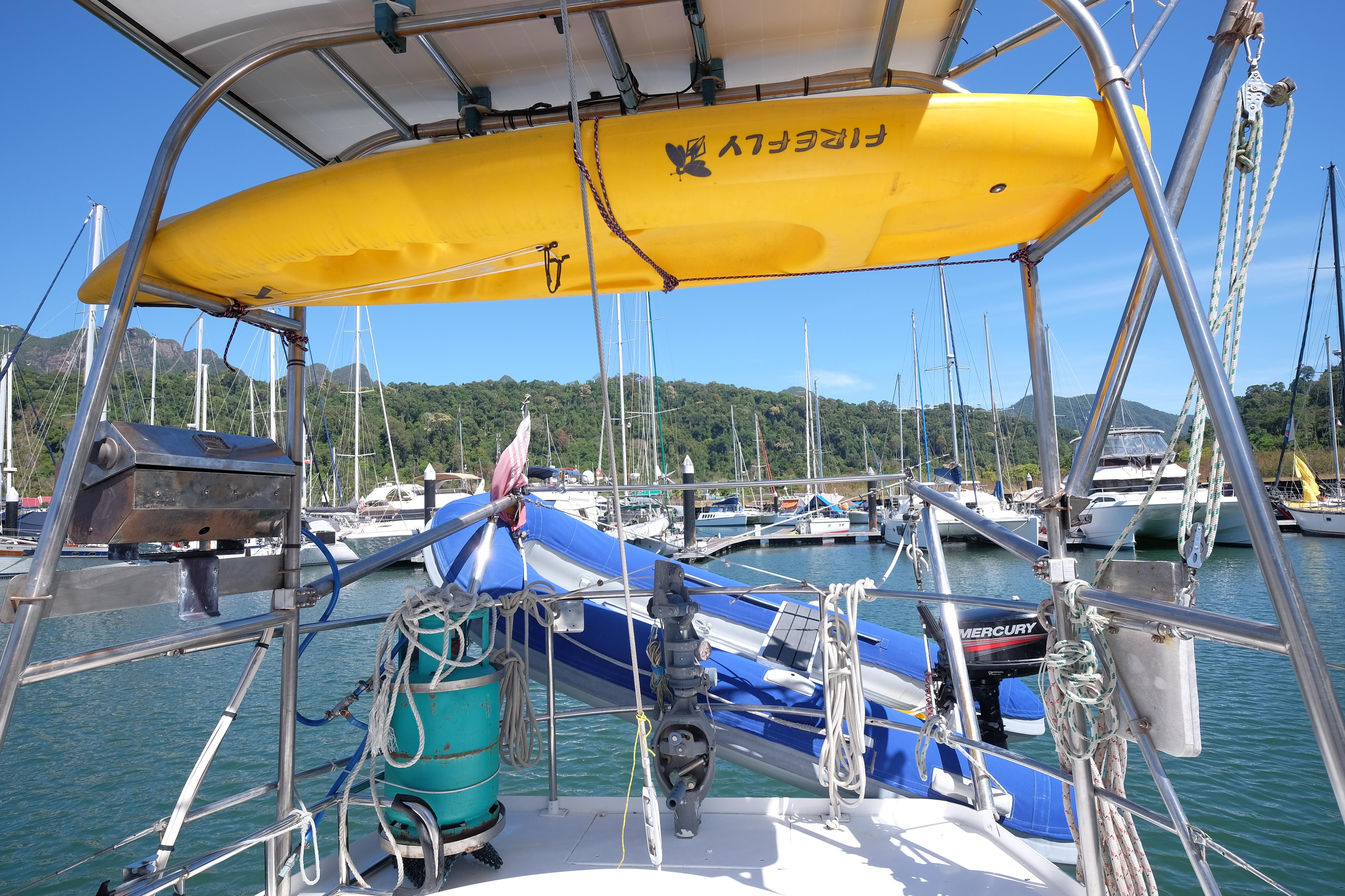 1981 Corbin 39 sailboat with yellow kayak, docked in a scenic marina.