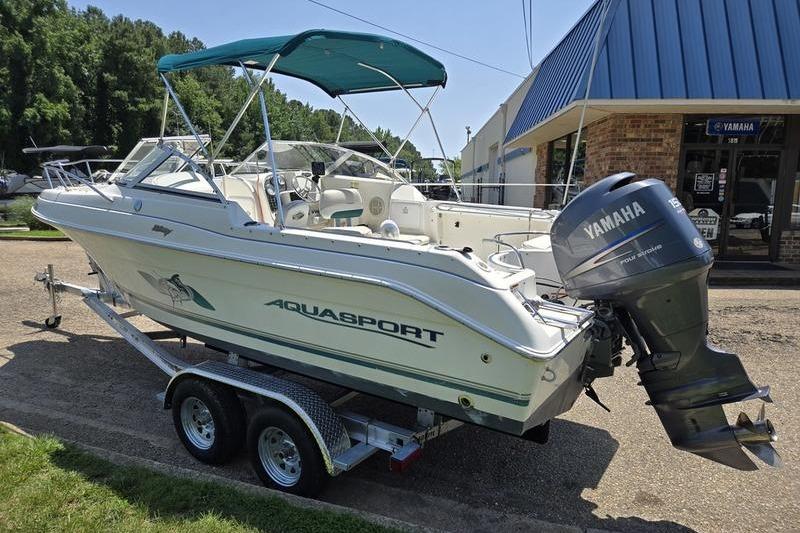 2004 Aquasport 215 Osprey Sport boat on trailer with Yamaha outboard motor.