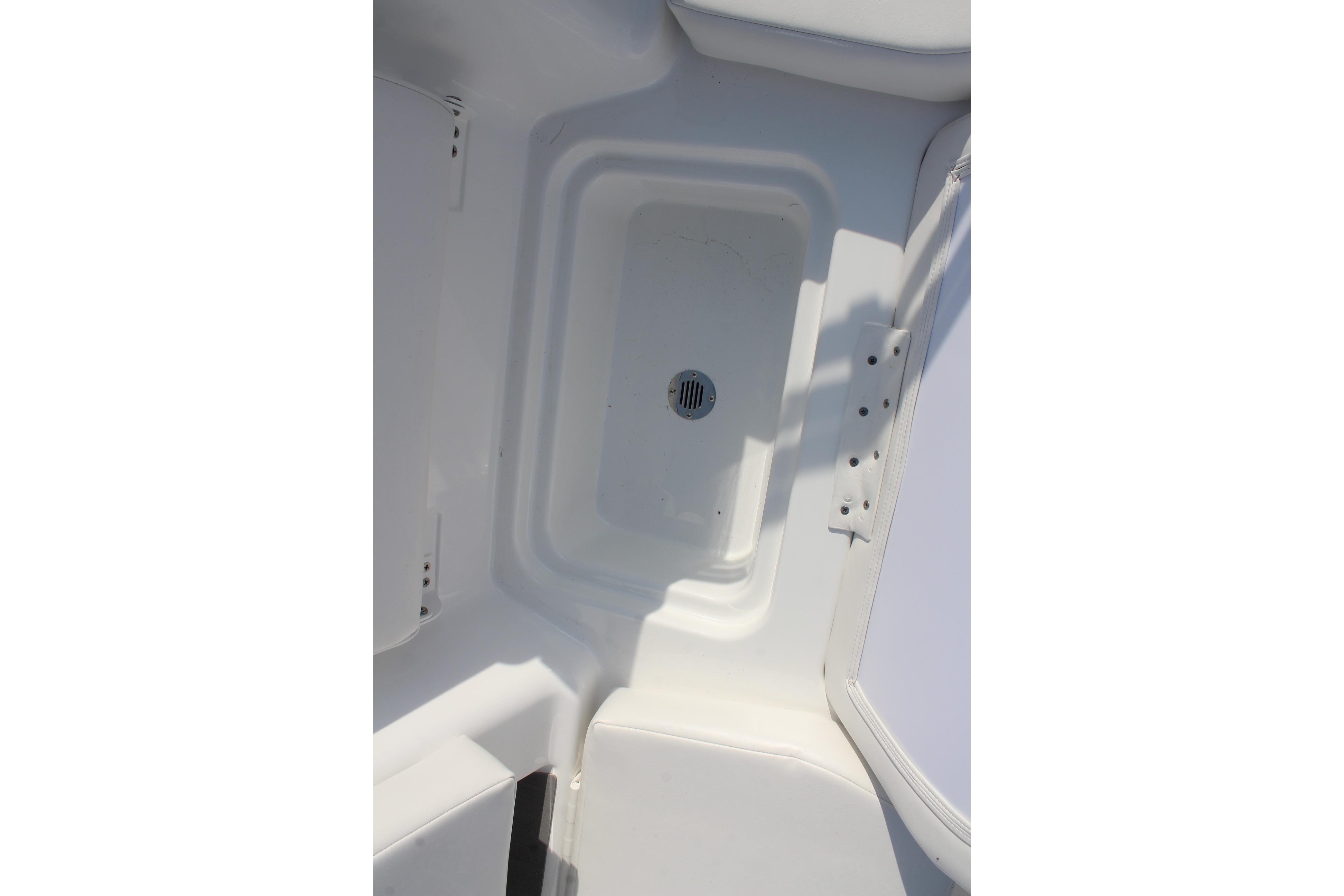 2026 Tahoe T18 boat interior with white storage compartment and drain.