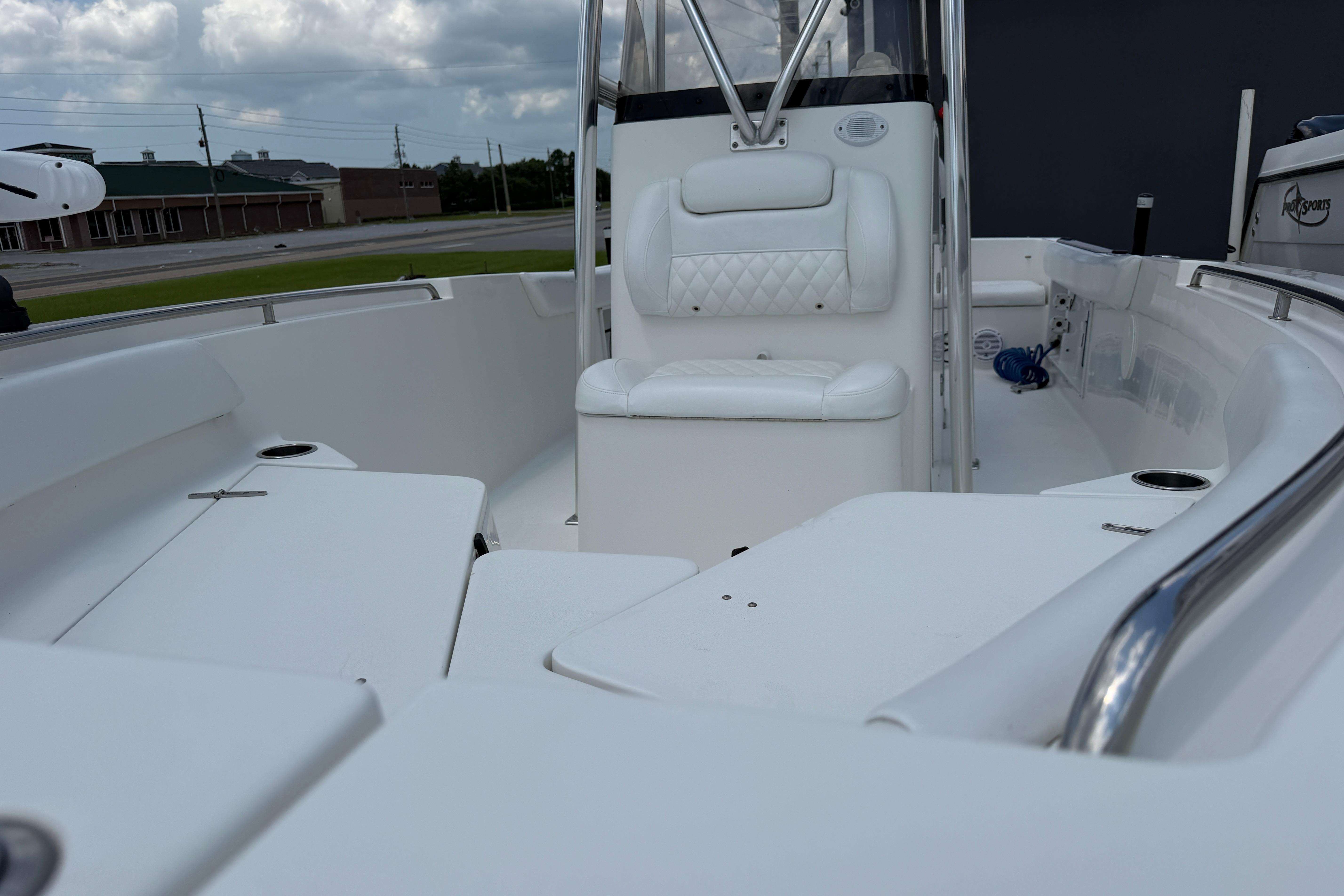 2015 Sea Hunt Triton 225 boat interior with white seating and stainless steel railings.
