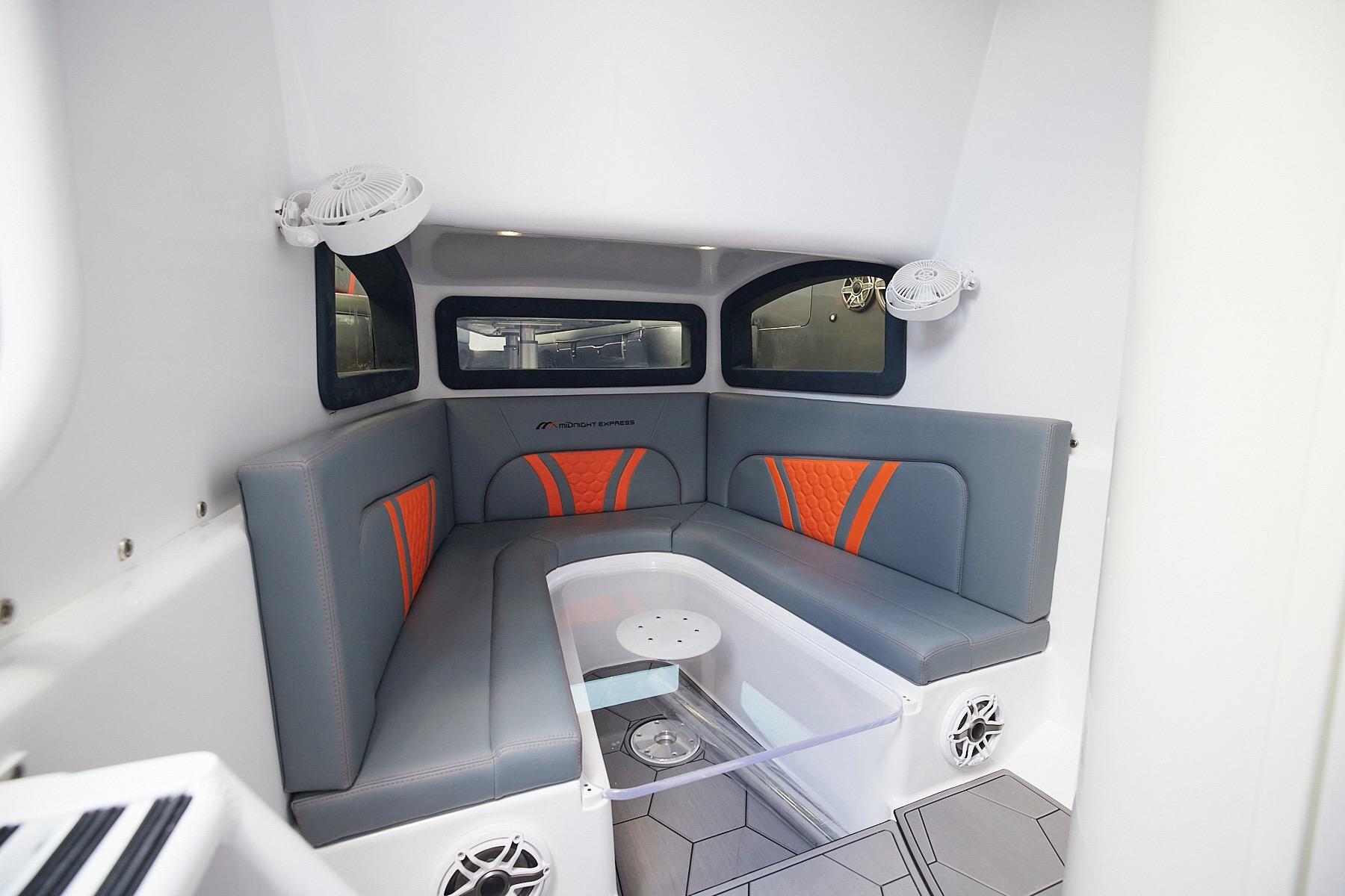 Interior of 2022 Midnight Express 43 Open boat with gray and orange seating.