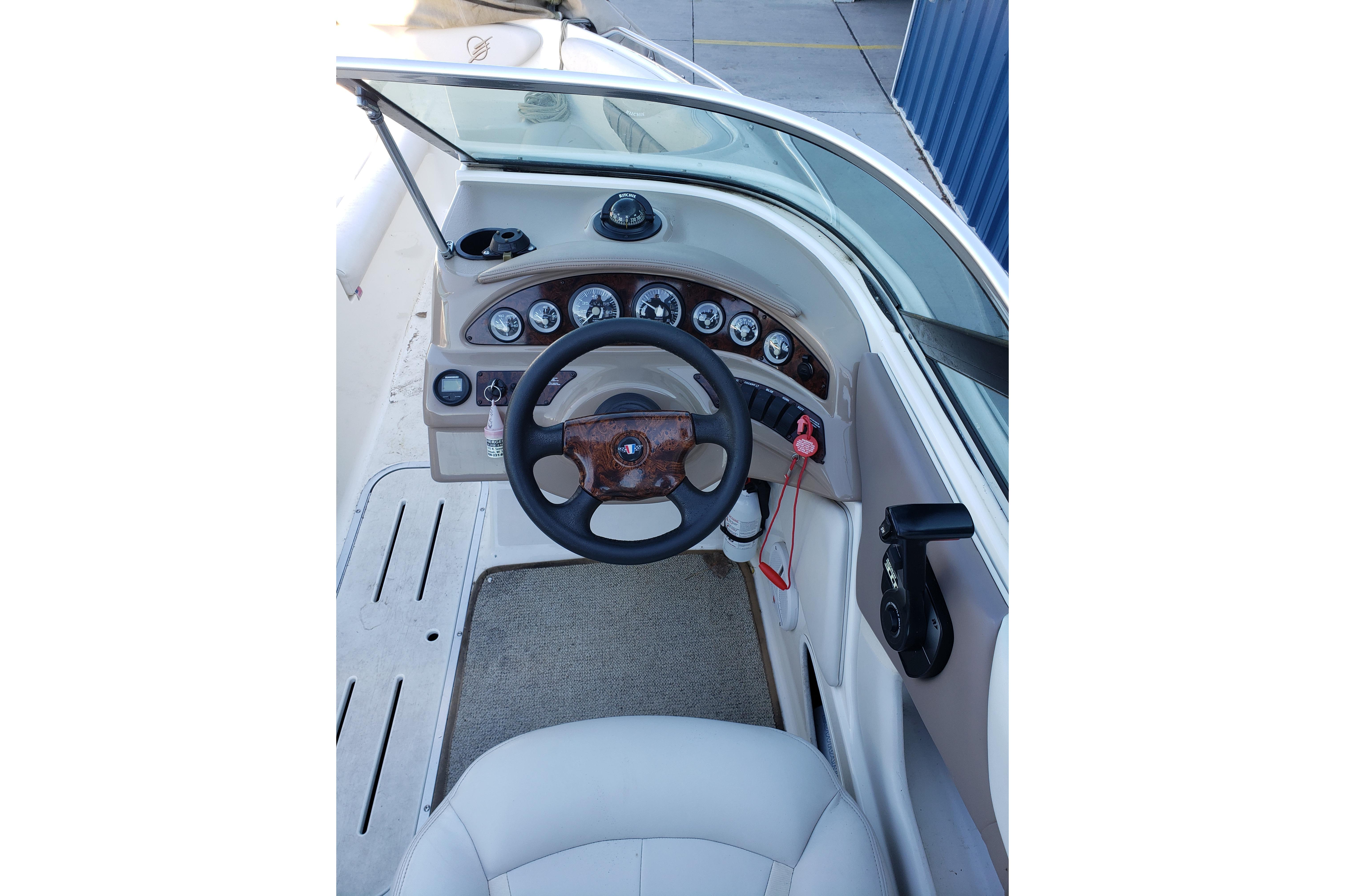 1998 Wellcraft Eclipse 2000 SS boat dashboard with steering wheel and instrument panel.