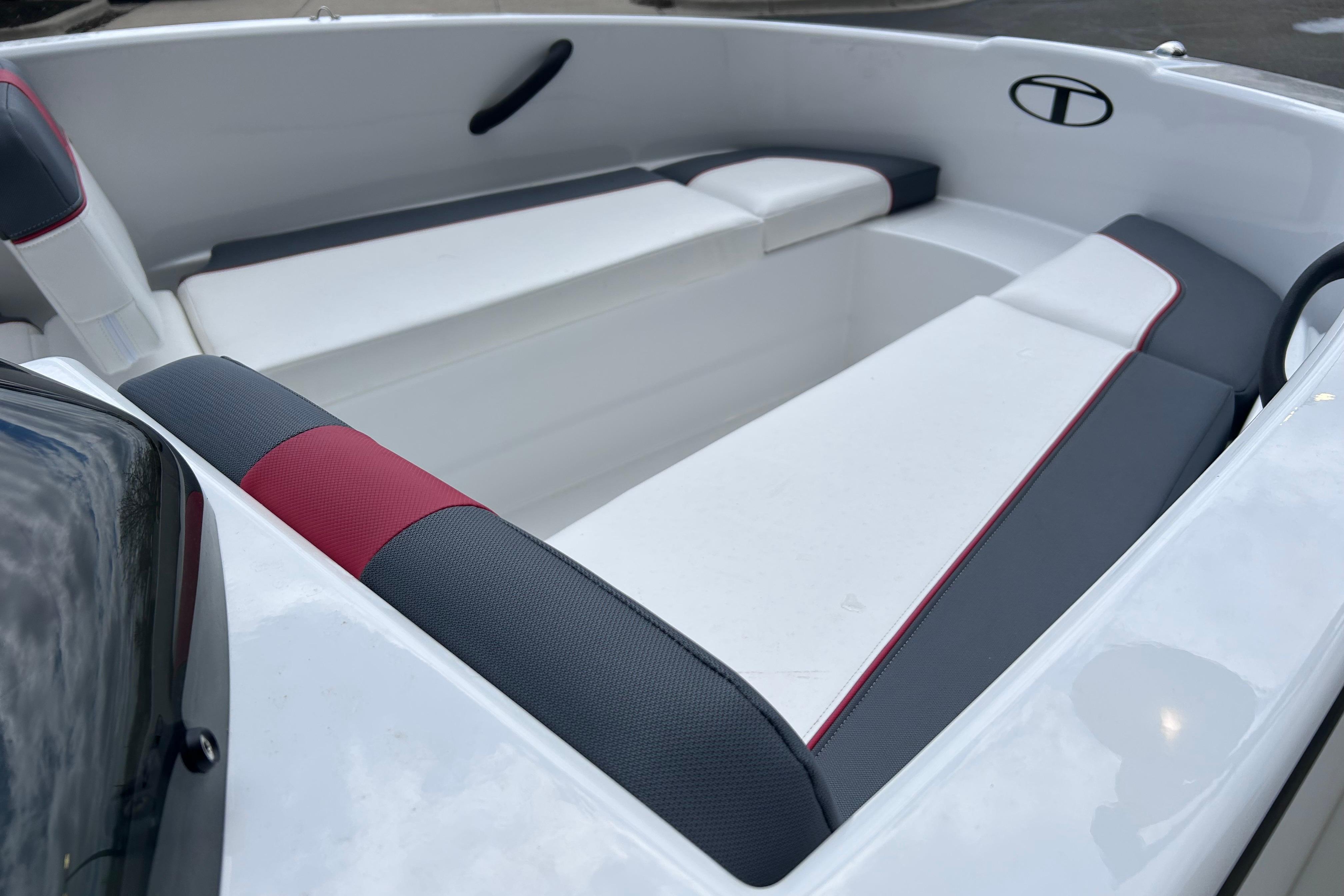2026 Tahoe T16 boat interior with white and gray seating, featuring red accents.