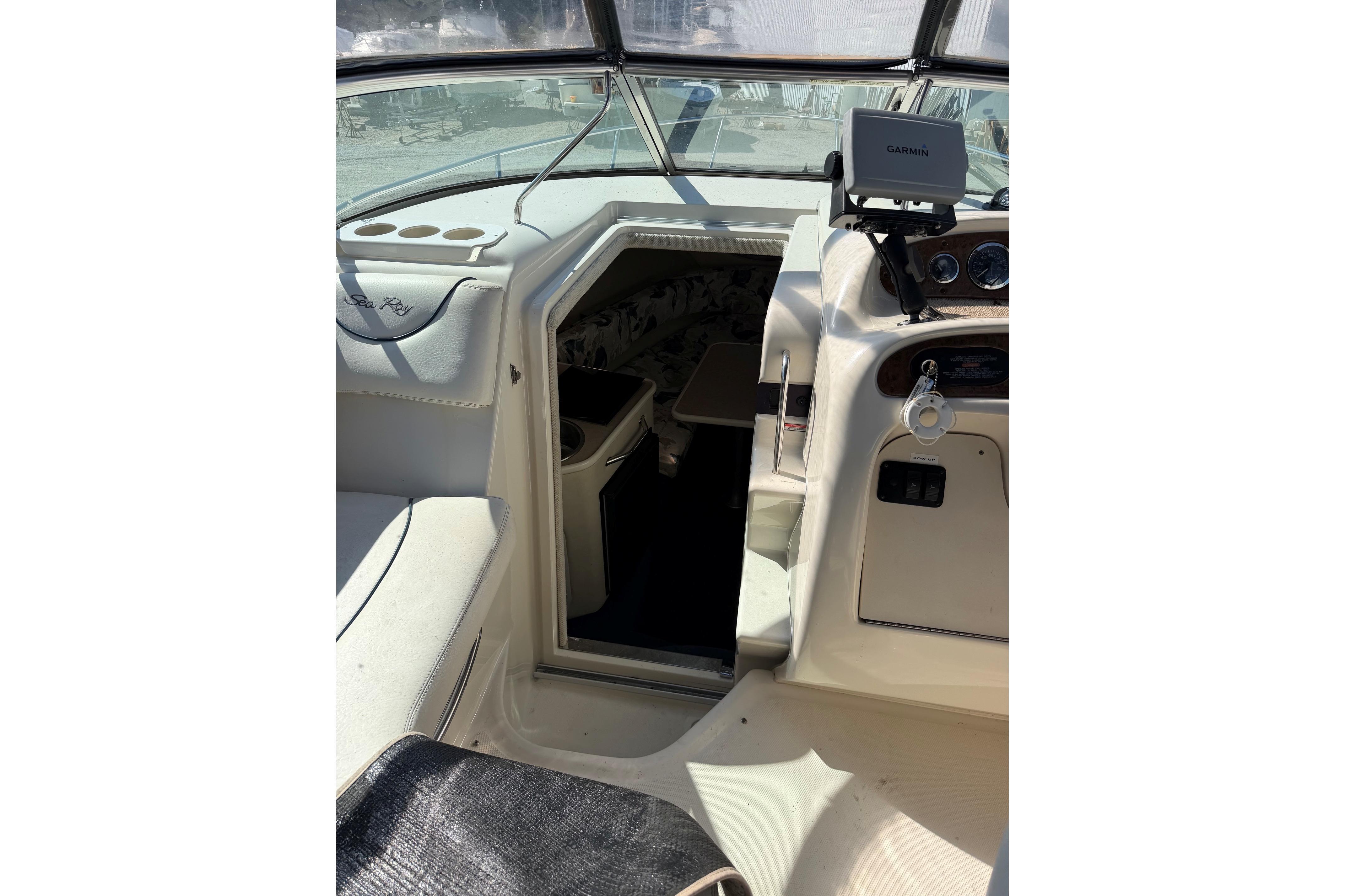 Interior view of a 2000 Sea Ray 240 Sundancer boat cockpit and cabin entrance.