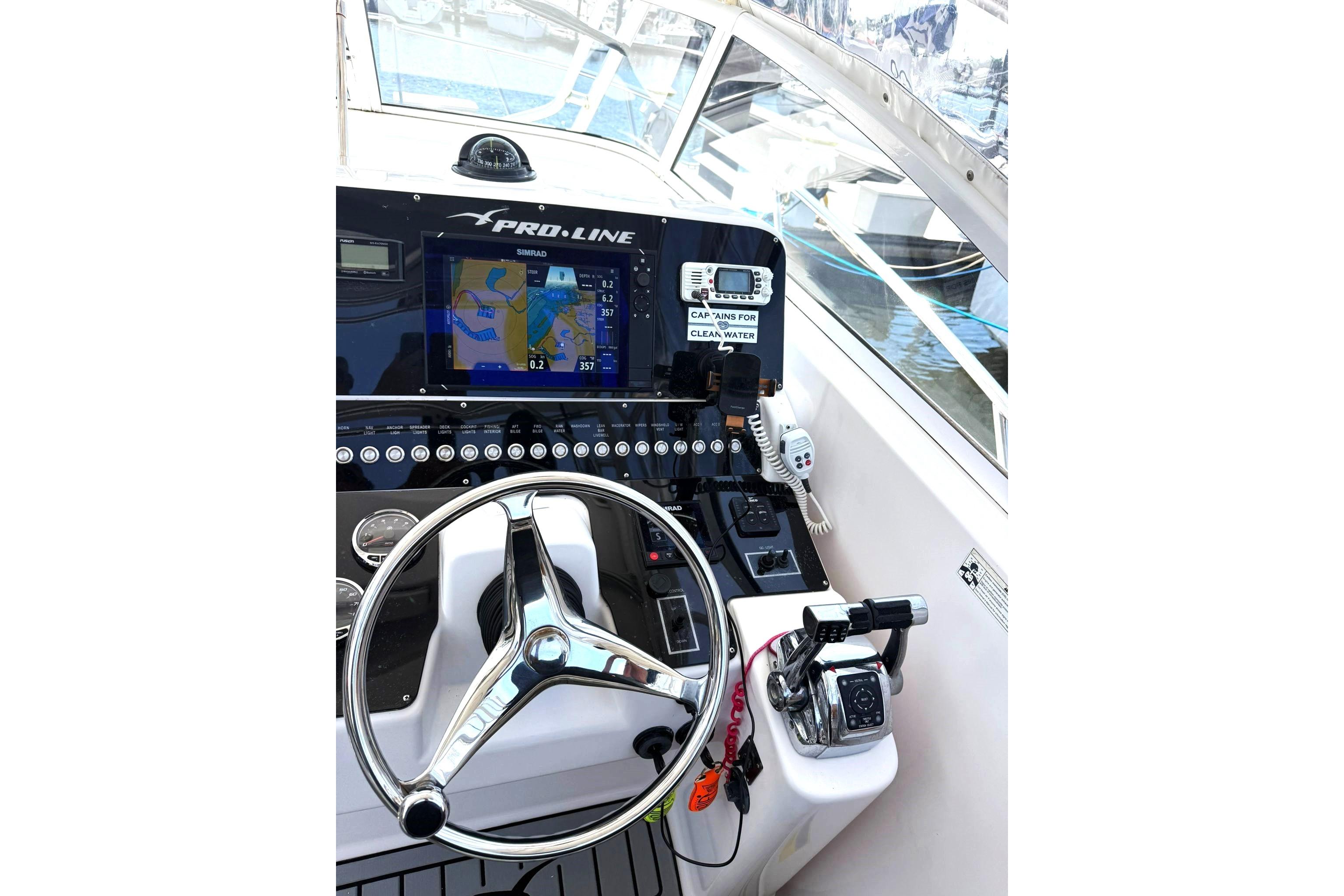 2006 Pro-Line 32 Express boat helm with navigation system and steering wheel.