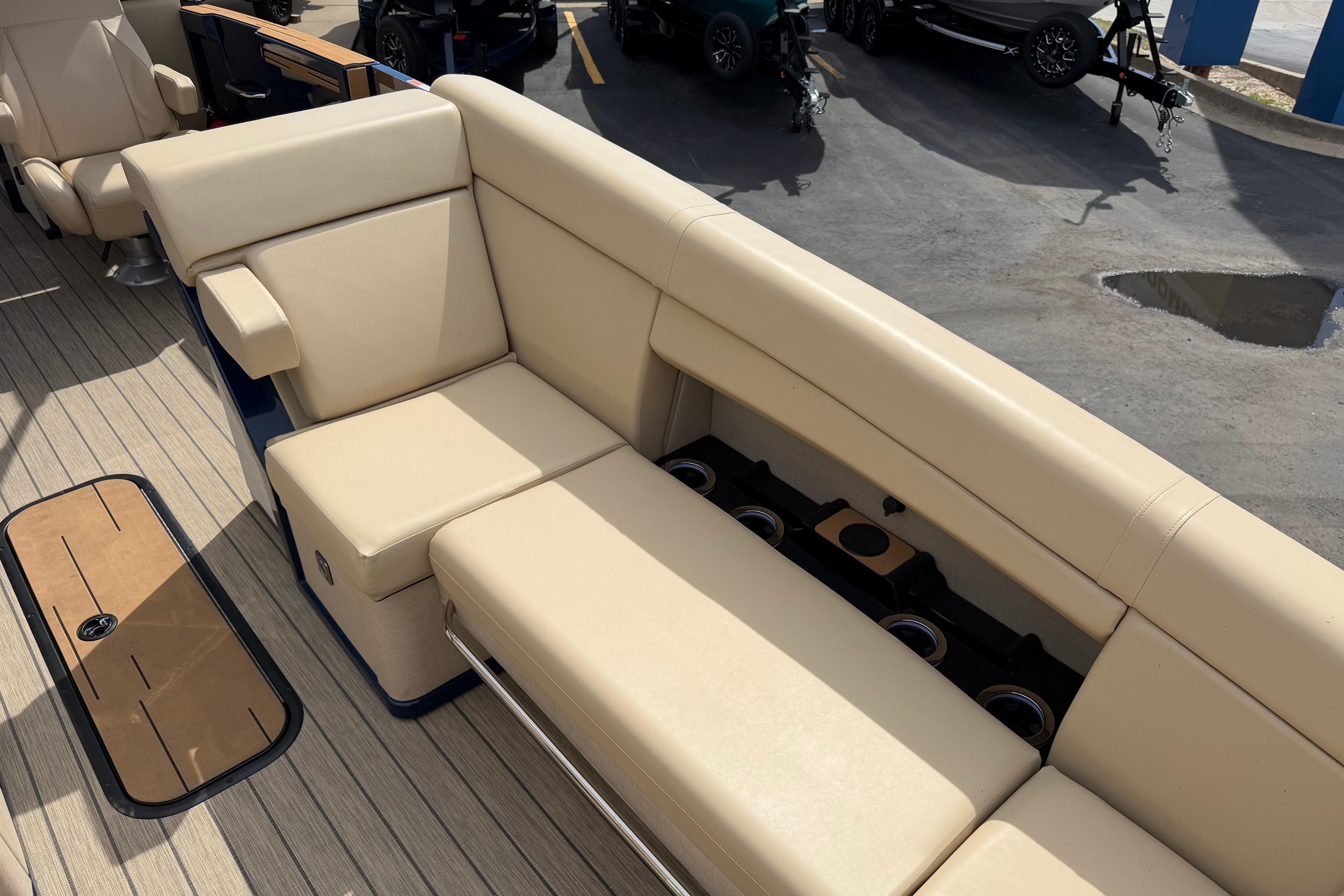 Luxurious seating on 2025 Balise HORIZON26C boat with beige upholstery and cup holders.