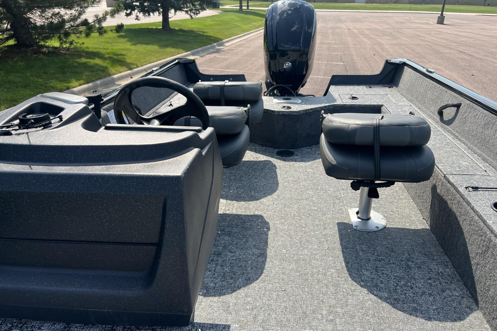 2026 Tracker Pro Guide V-16 SC boat interior with steering console and seating.