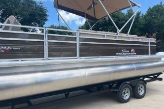 2025 Sun Tracker Sportfish 24 XP3 pontoon boat with canopy on trailer.