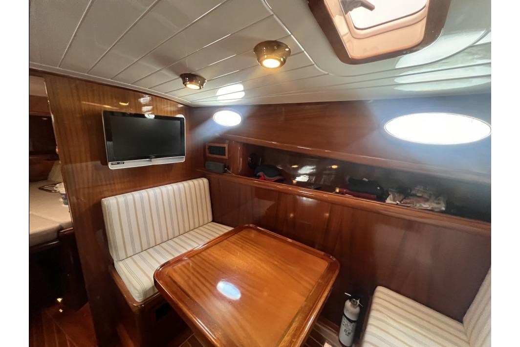 Luxurious interior of 2004 RB DERELI Daytripper 40 yacht with wood finish and seating area.