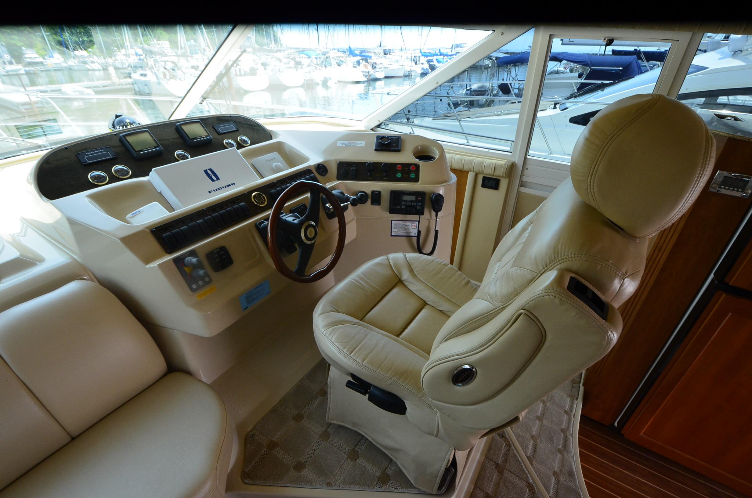 2003 Cruisers Yachts 5000 Sedan Sport helm with leather captain's chair and control panel.