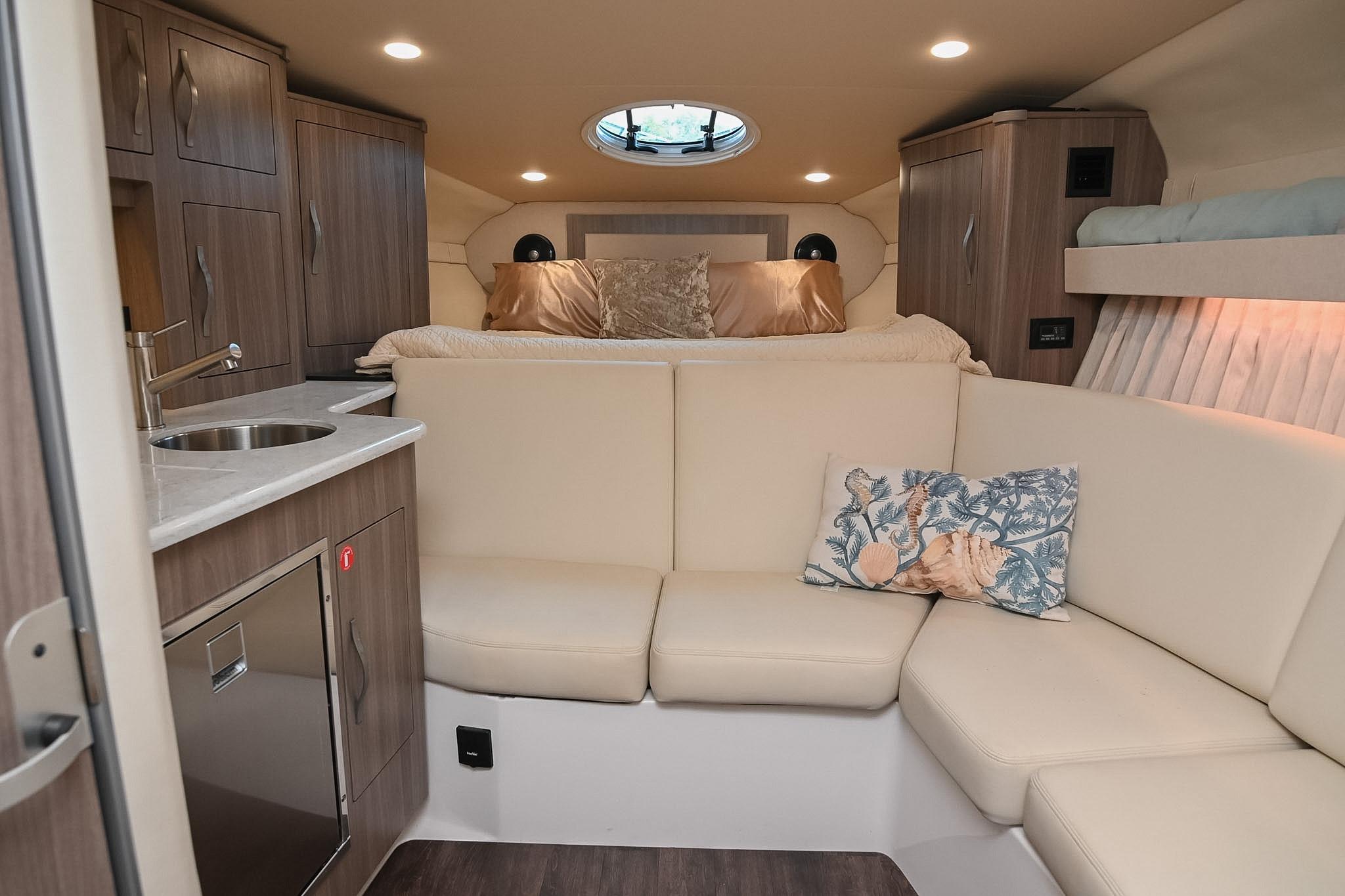 Luxurious interior of 2021 Regal 33 Express yacht with cozy seating and modern amenities.