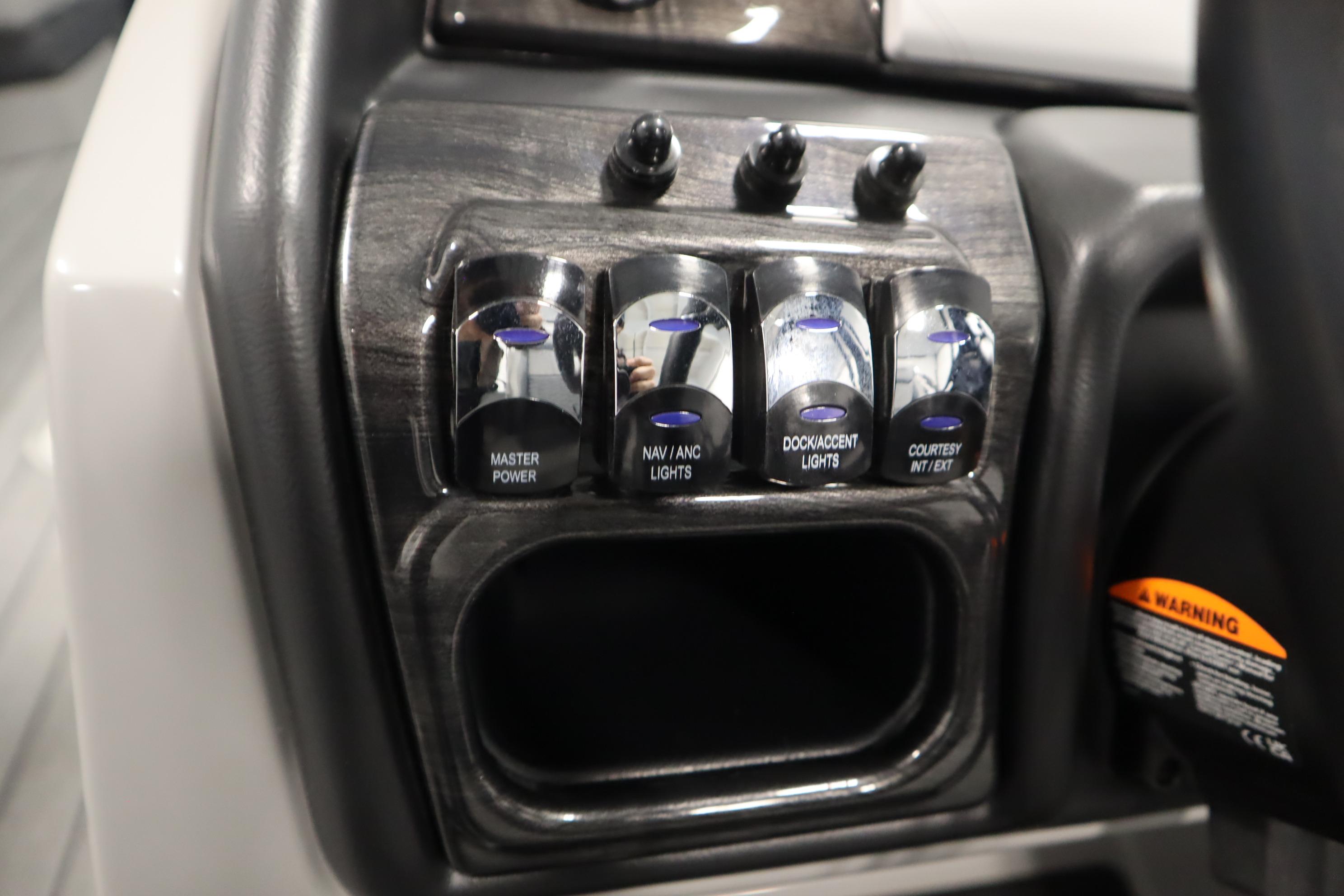 Control panel of 2025 Bentley Pontoons Elite 253 Admiral Tri-toon with labeled switches.