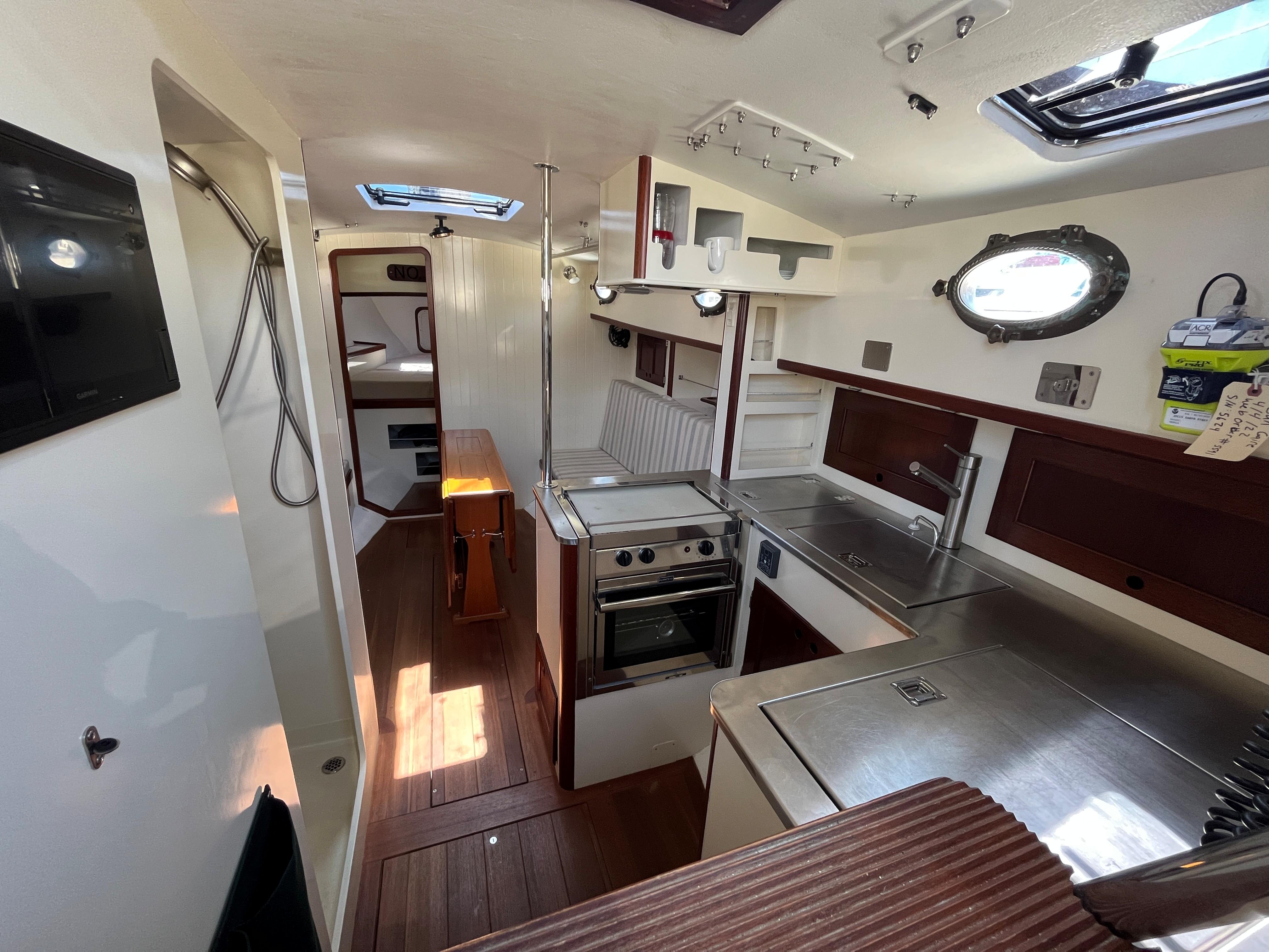 Interior of 2016 Alajuela 38 sailboat with modern kitchen and wooden flooring.