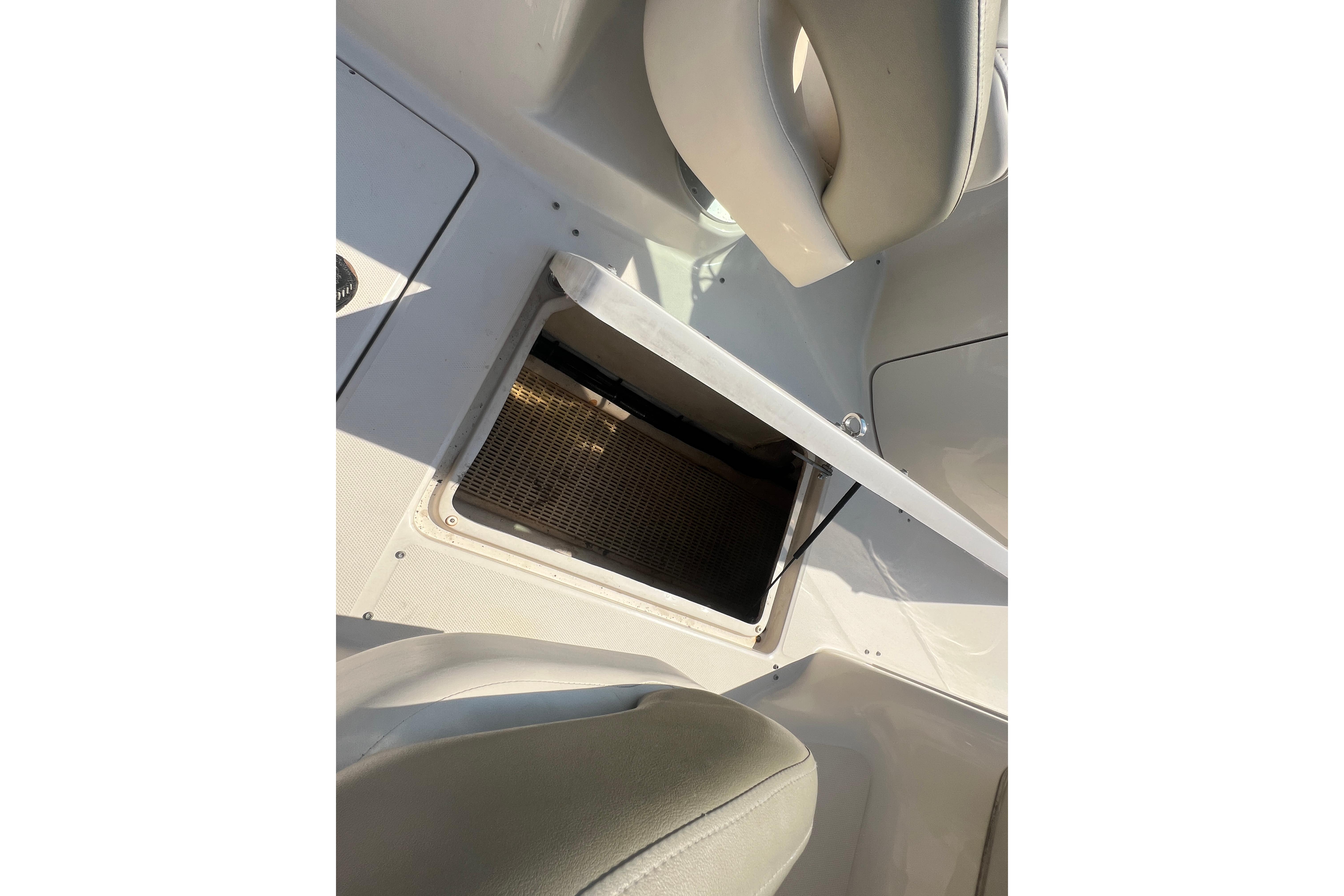 Open storage compartment on 2005 Sea Ray 240 Sundeck boat interior.