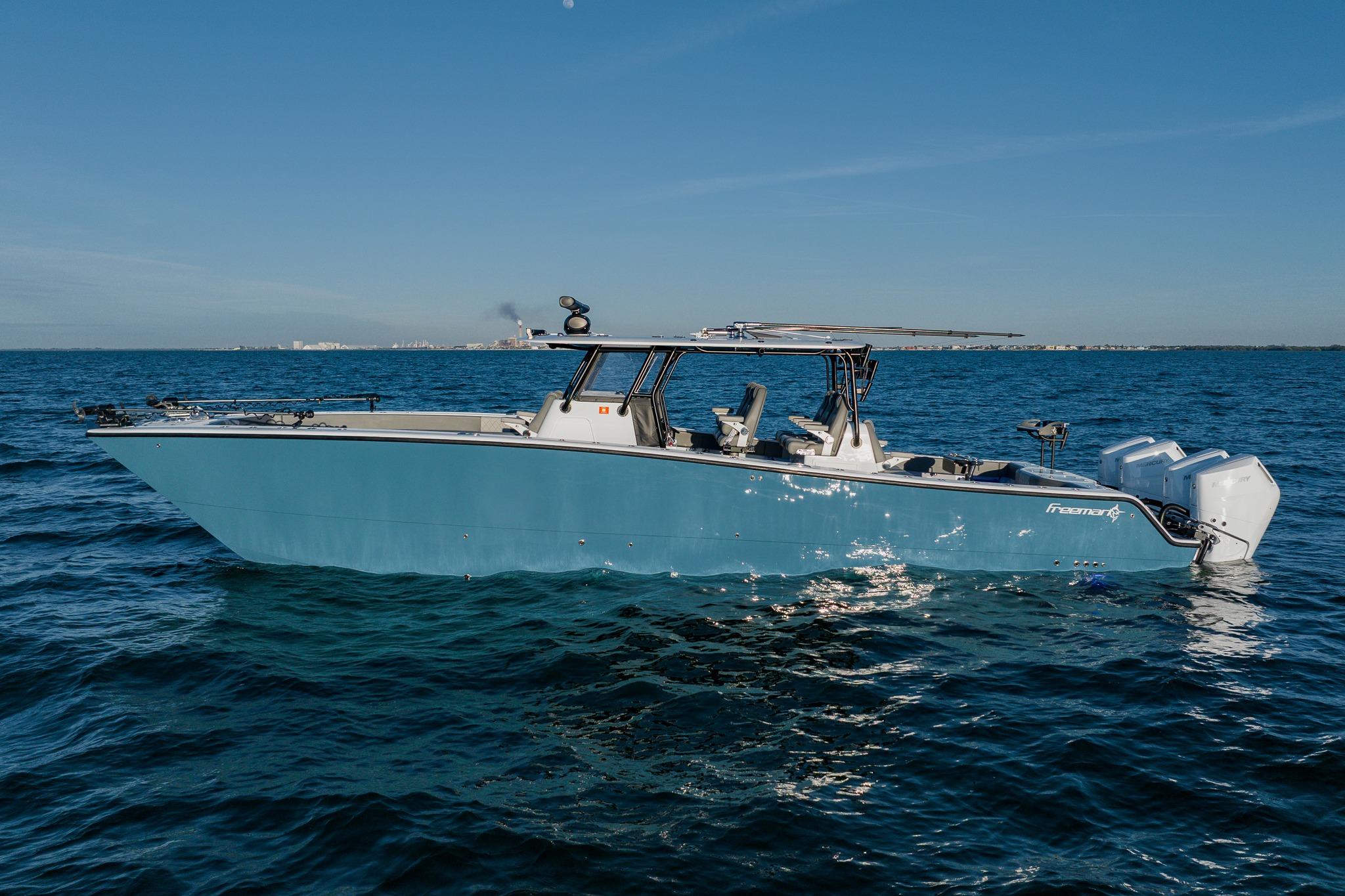 2025 Freeman 42LR boat on open water, clear sky, side view.