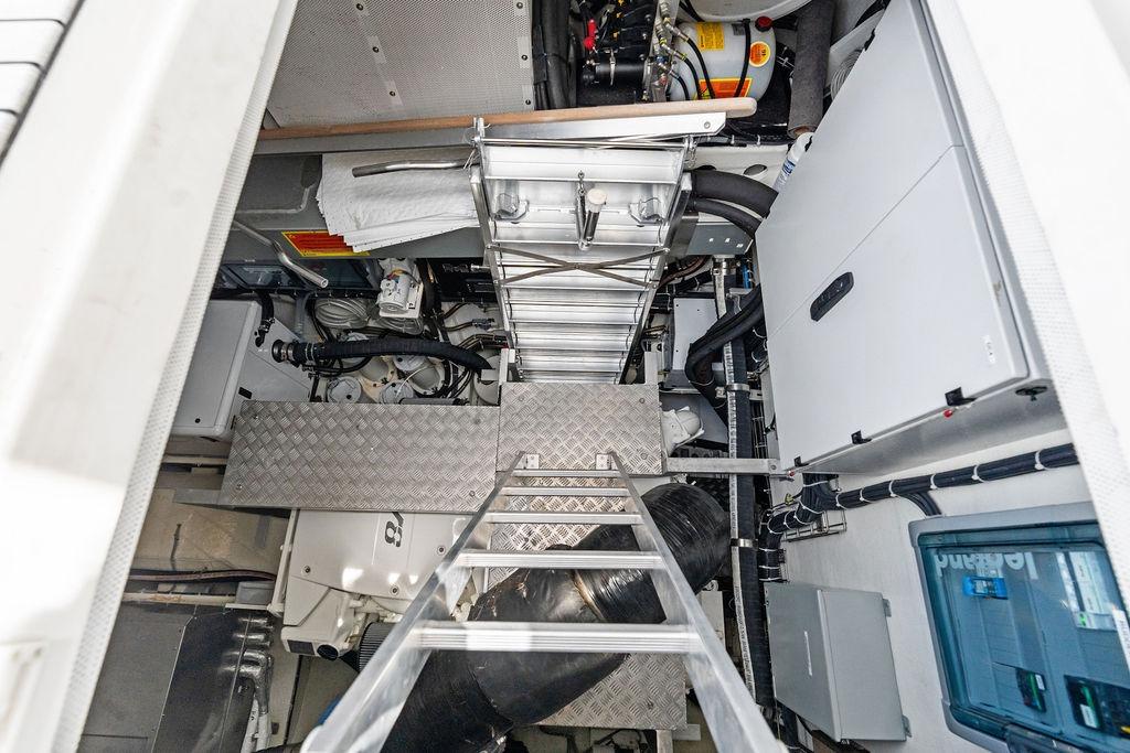Engine room of 2024 Sunreef 80 Power yacht, featuring machinery and access ladder.