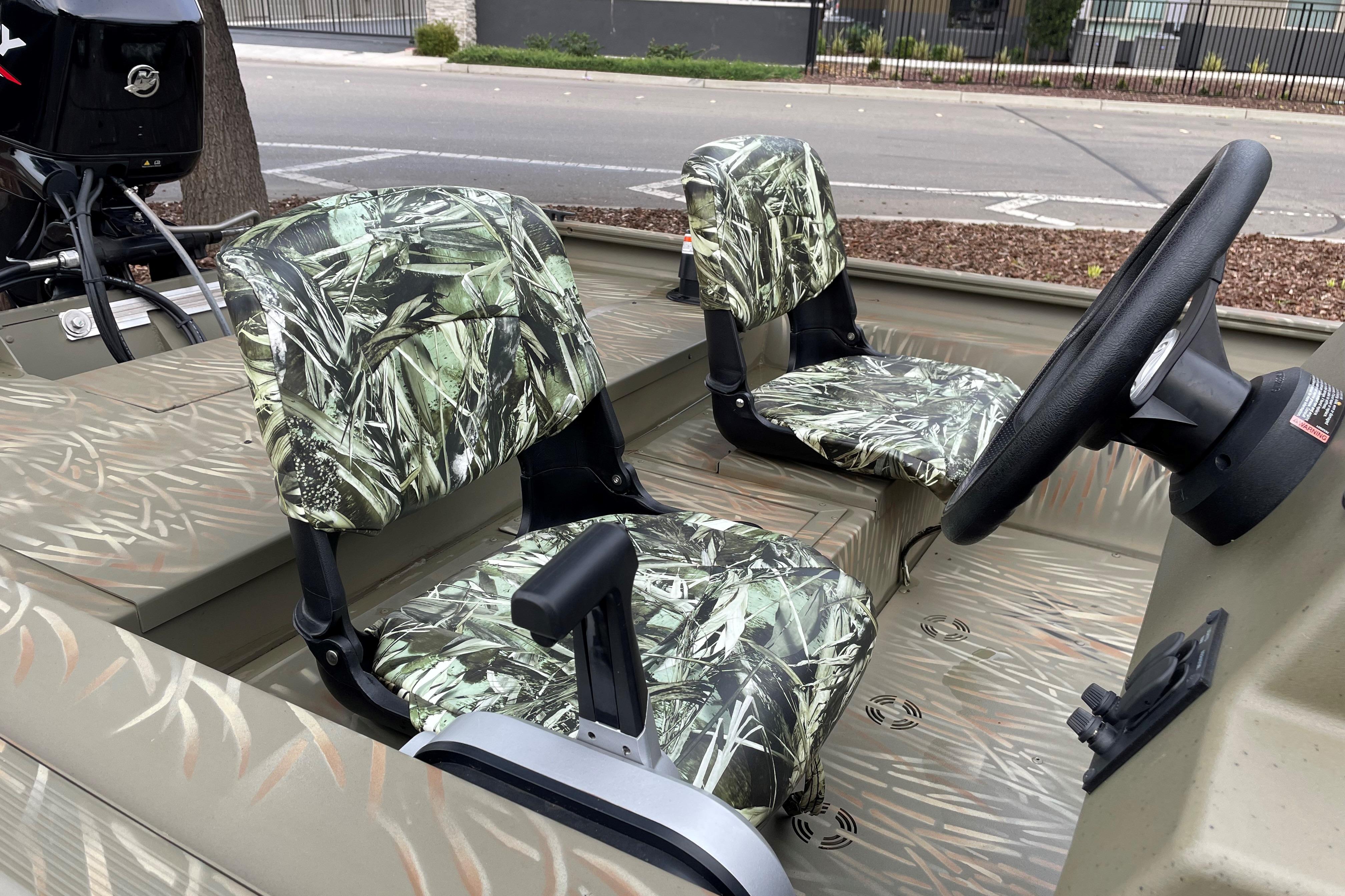 2025 Tracker Grizzly 1754 SC boat interior with camo seats and steering wheel.