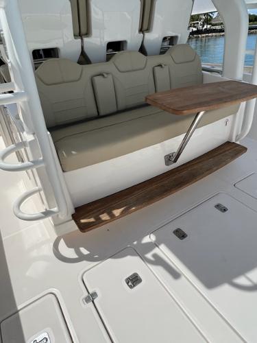 2019 Pursuit S 408 Sport boat interior with beige seating and wooden table.