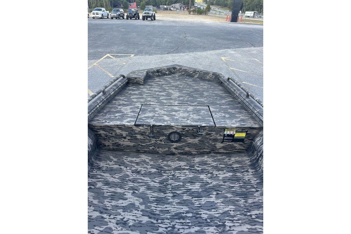 2025 Havoc 1860 boat with camouflage interior, parked in a lot.