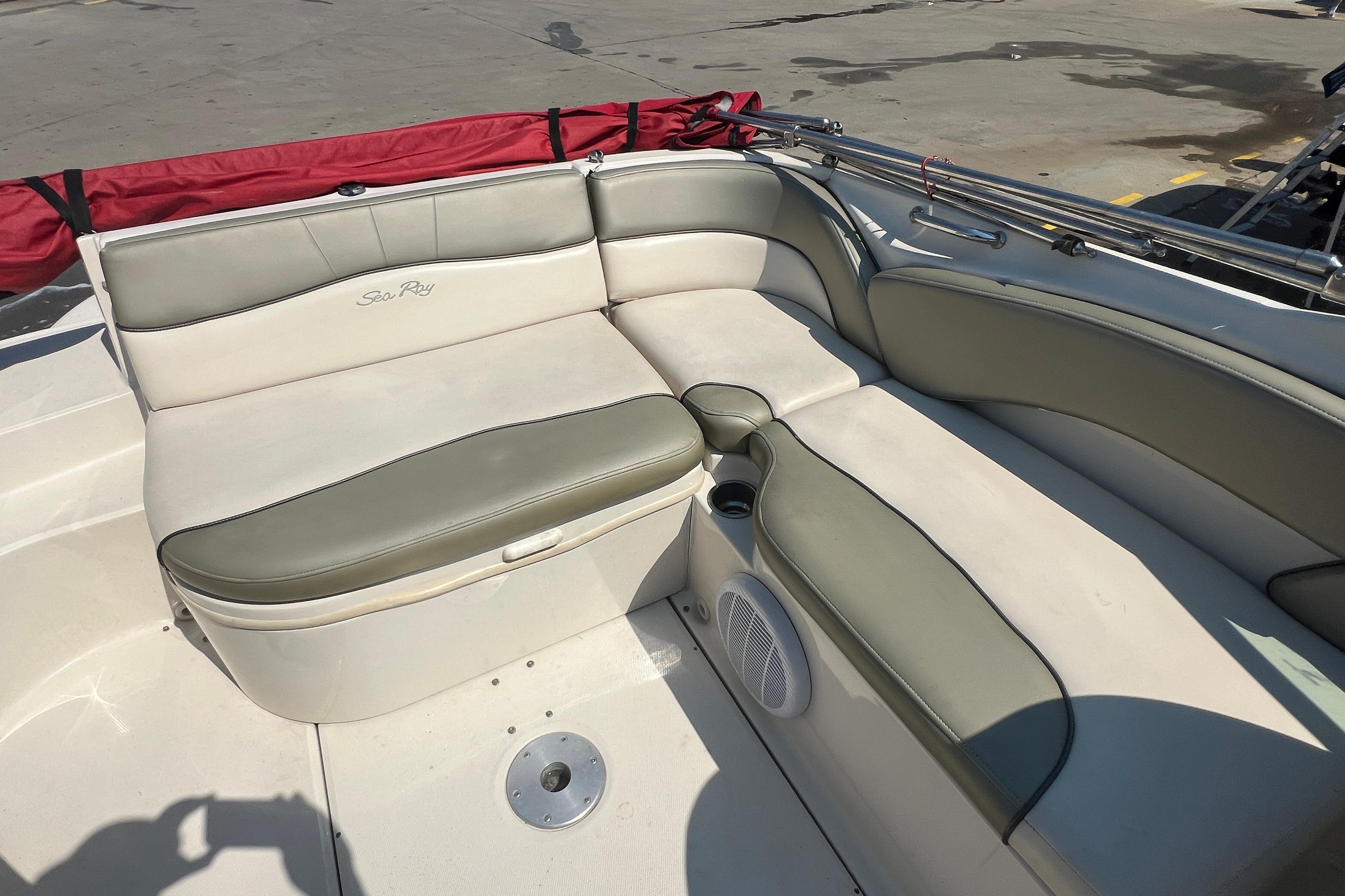 2005 Sea Ray 240 Sundeck boat interior with cushioned seating and speaker.