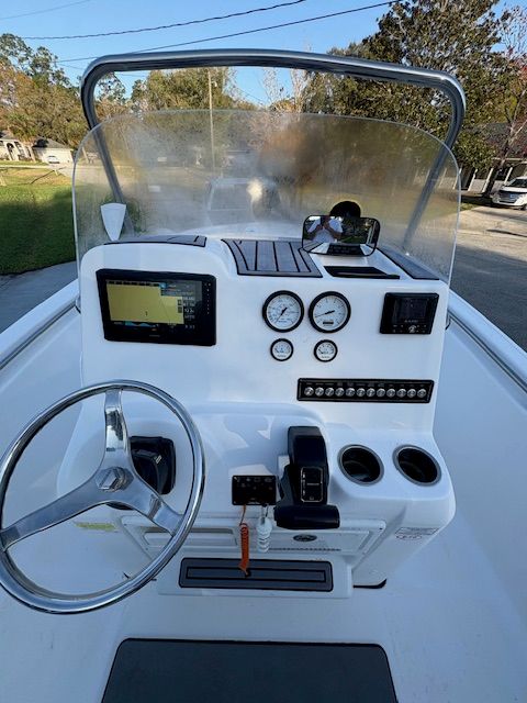 The image shows the helm of a 2024 Tidewater 198 CC Adventure boat with instruments and steering wheel.