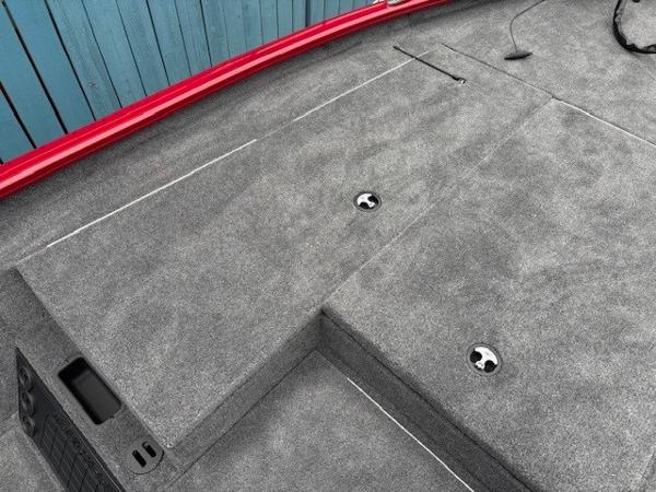 2025 Tracker Savage 215 boat deck with gray carpet and red trim.