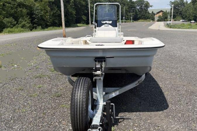 2026 Mako Pro Skiff 15 CC boat on trailer in parking lot.