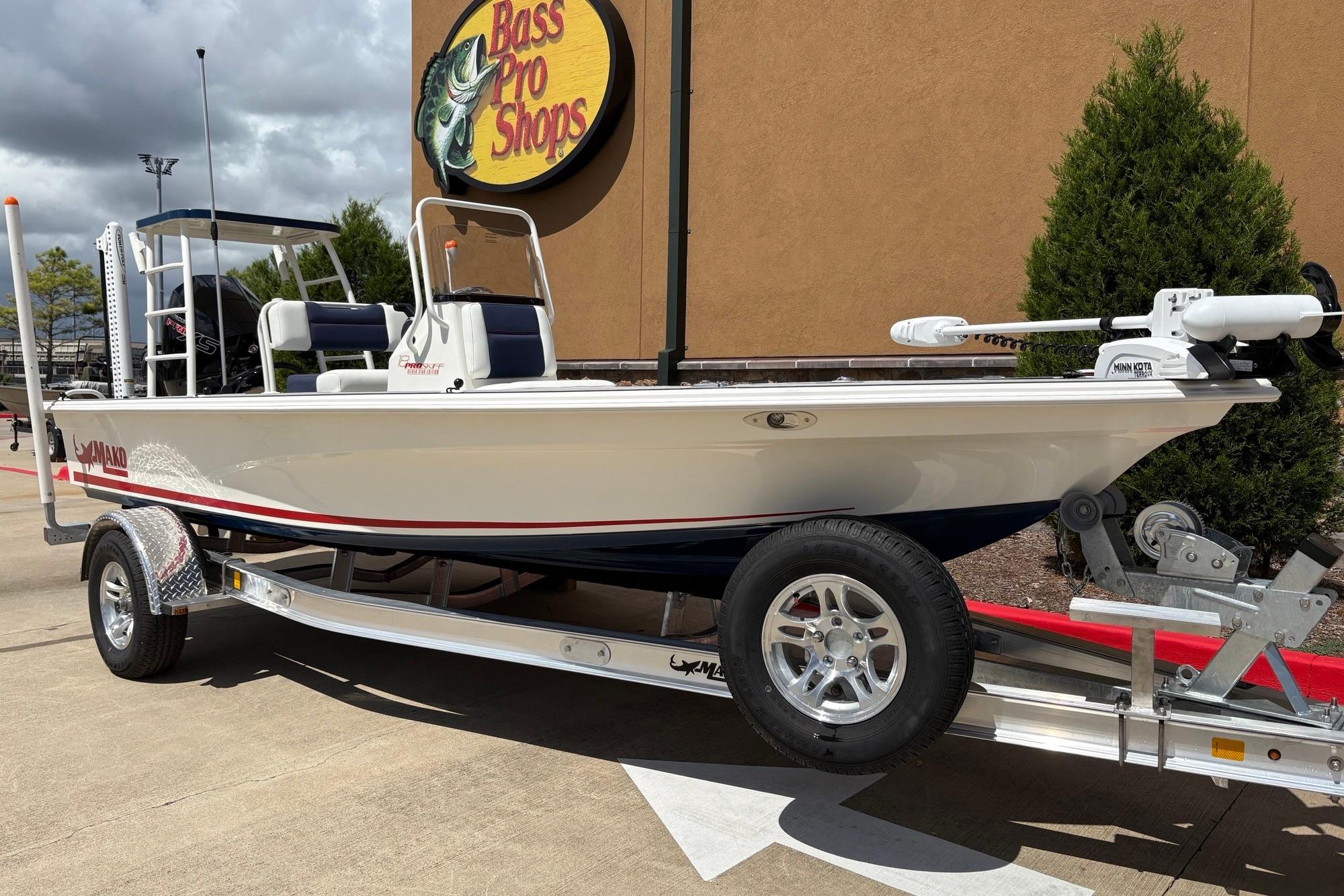2026 Mako 18 Pro Skiff Patriot Edition boat on trailer at Bass Pro Shops.