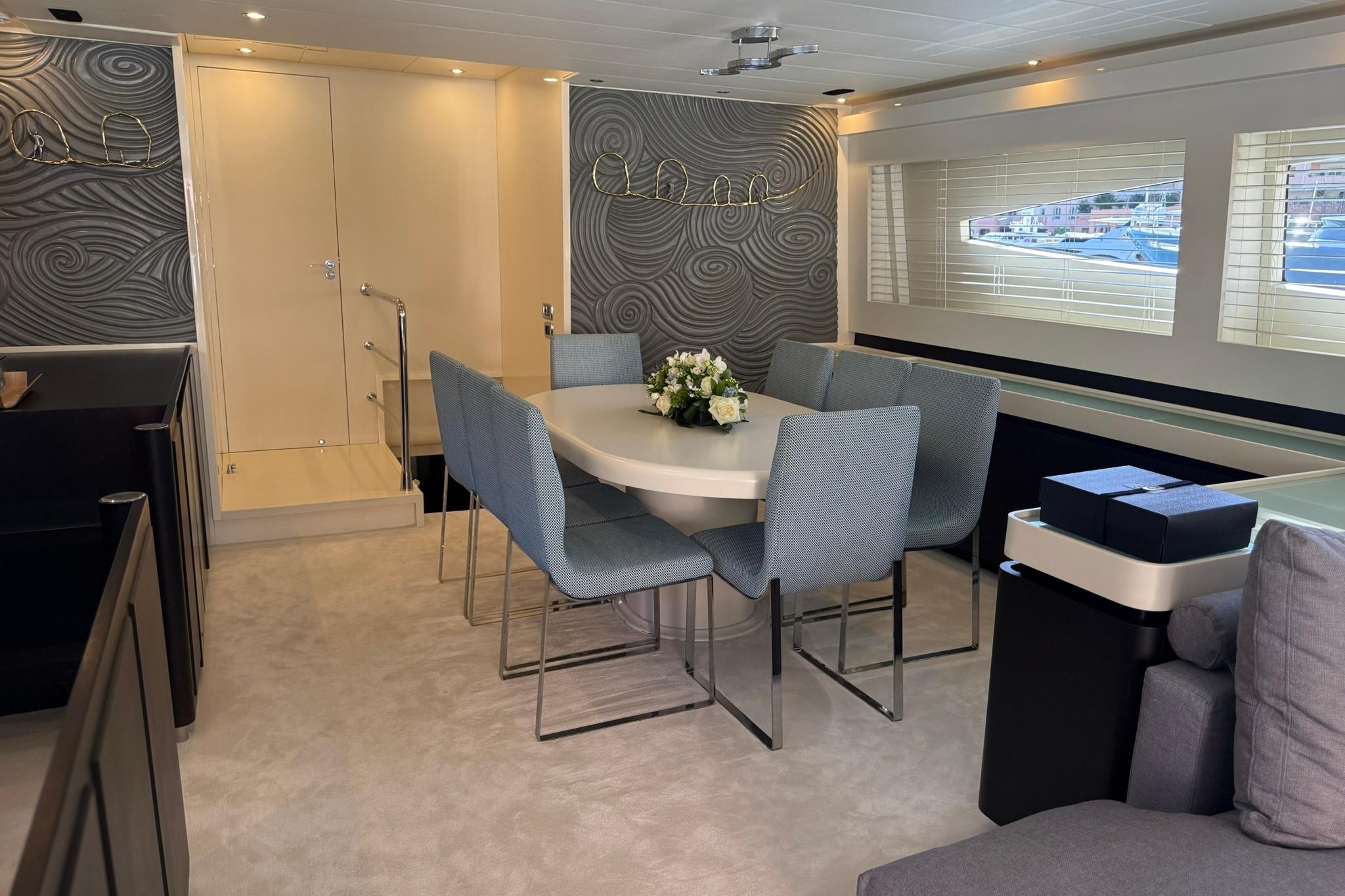 Luxurious dining area on a 2007 Canados 86 yacht with elegant decor and seating.