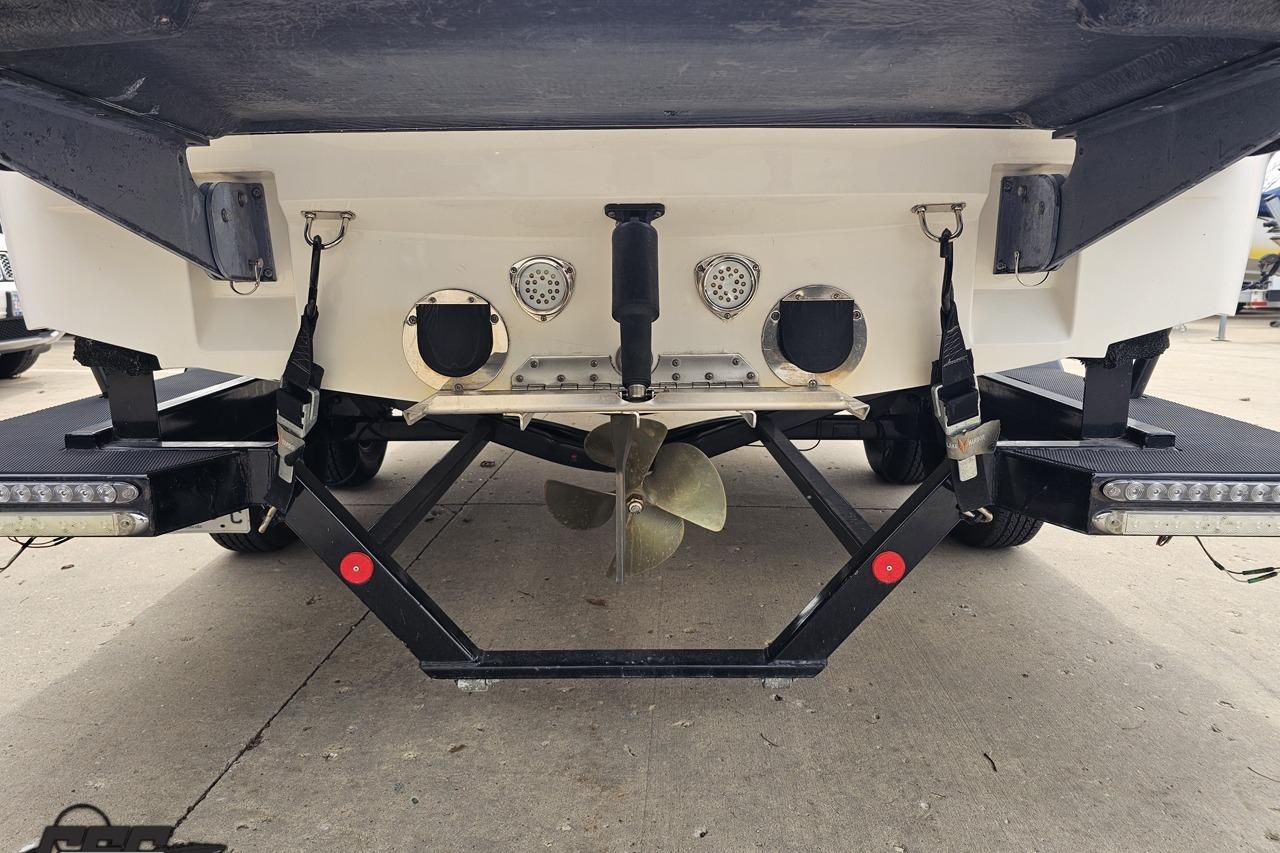 Rear view of a 2013 MasterCraft X-10 boat on a trailer, showing propeller and exhaust.