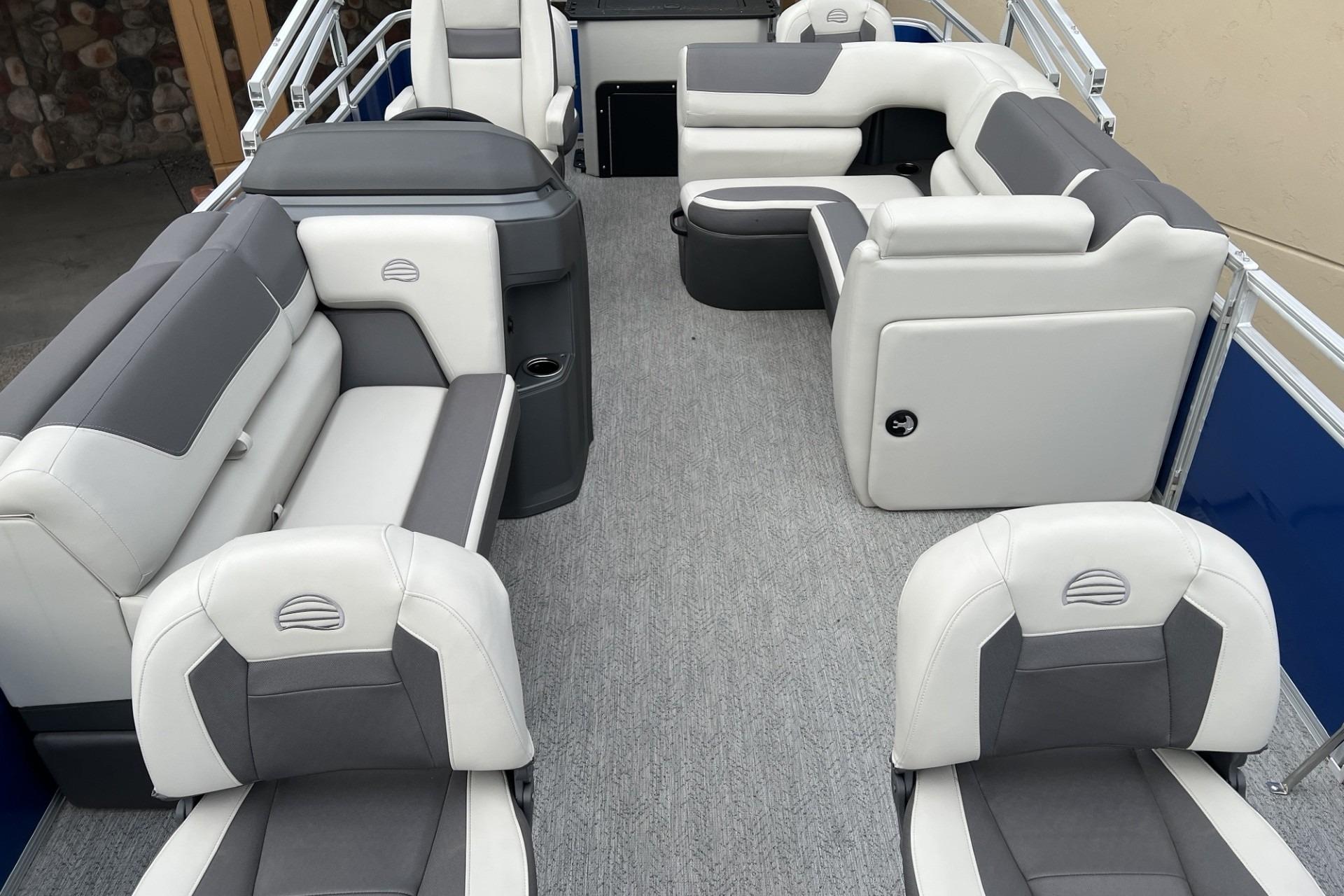 2026 Sun Tracker Fishin' Barge 20 DLX interior with gray and white seating.