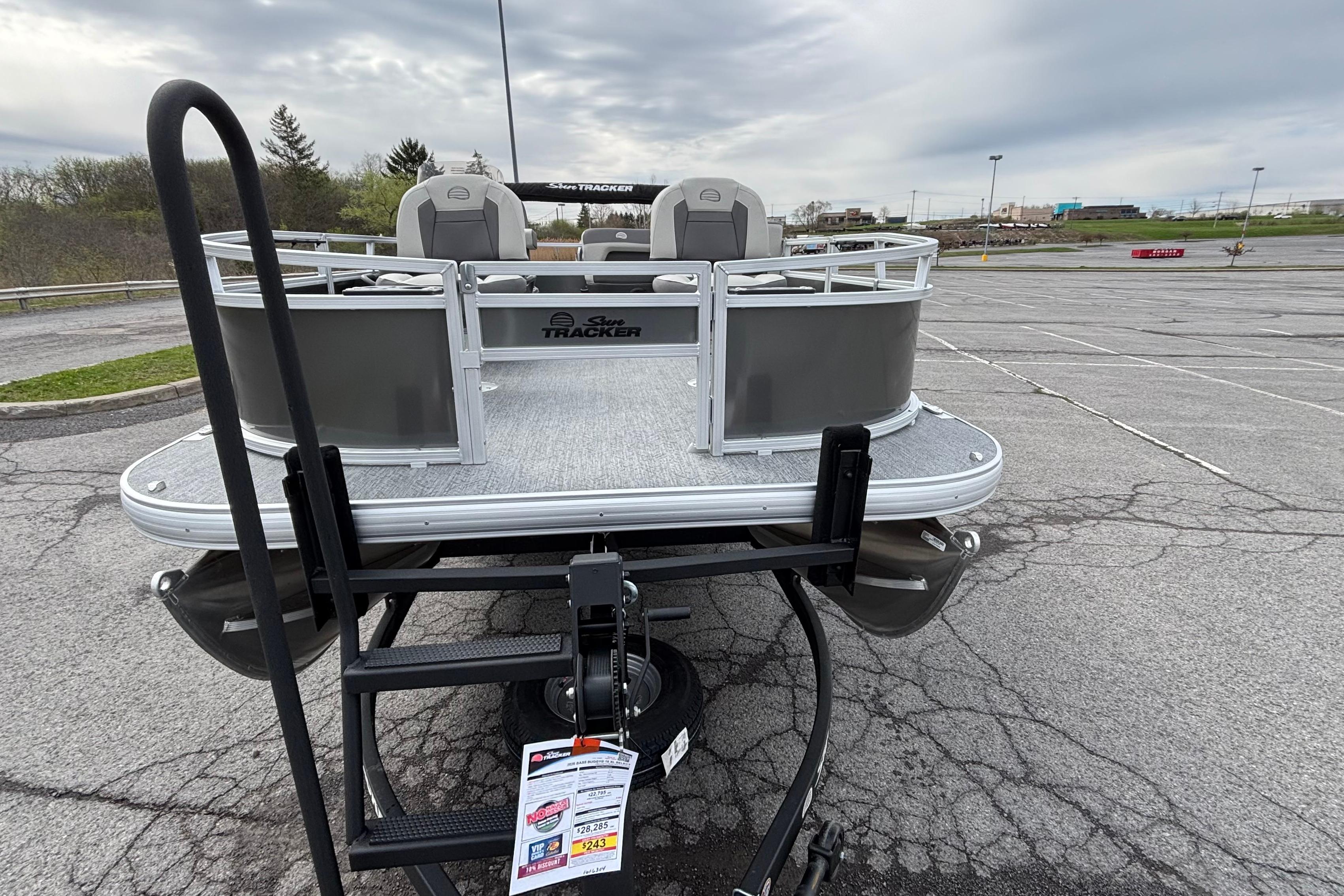 2026 Sun Tracker Bass Buggy 16 XL Select pontoon boat in a parking lot.