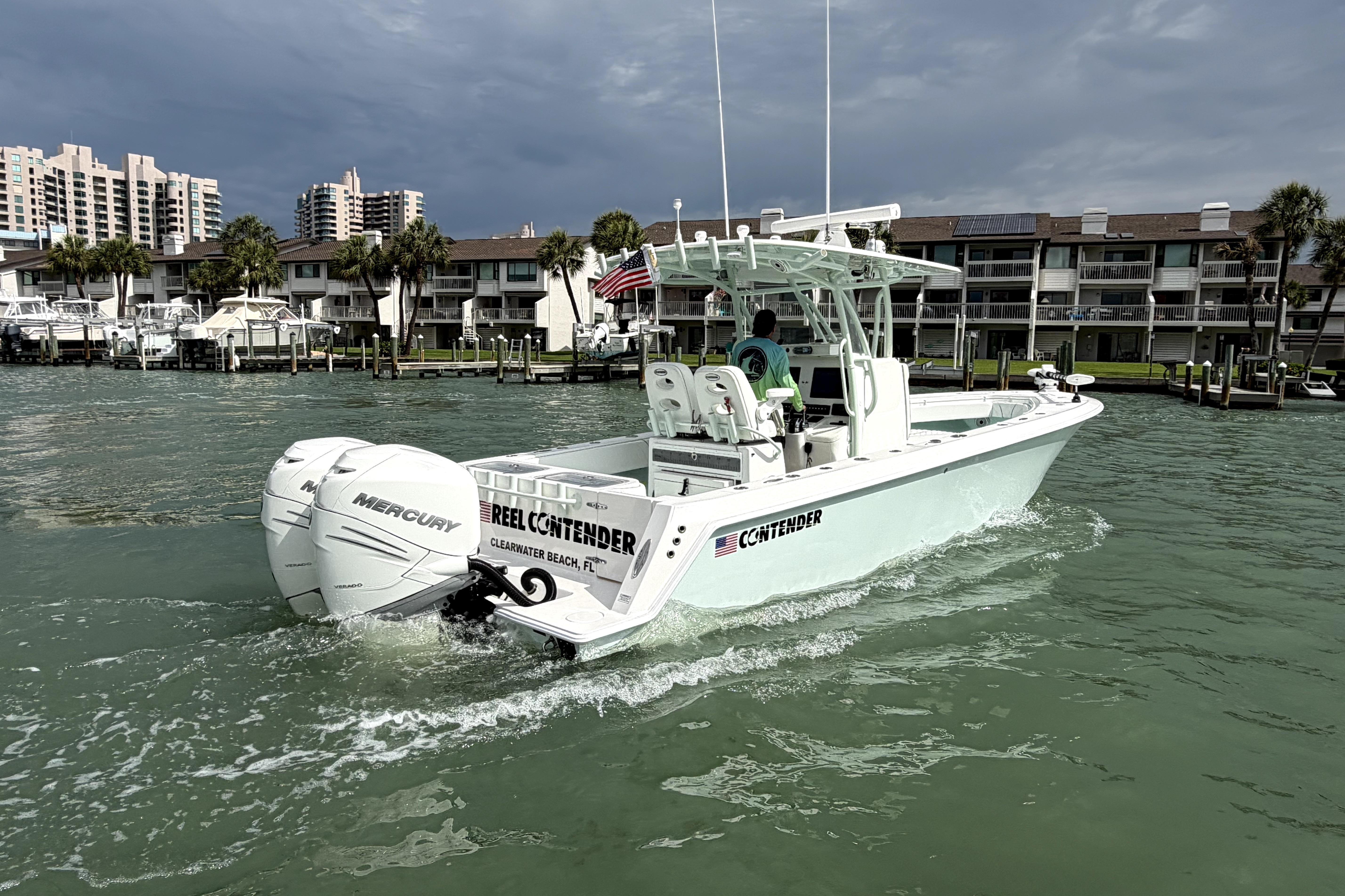 2019 Contender 30 ST boat cruising near Clearwater Beach, FL, with twin Mercury engines.