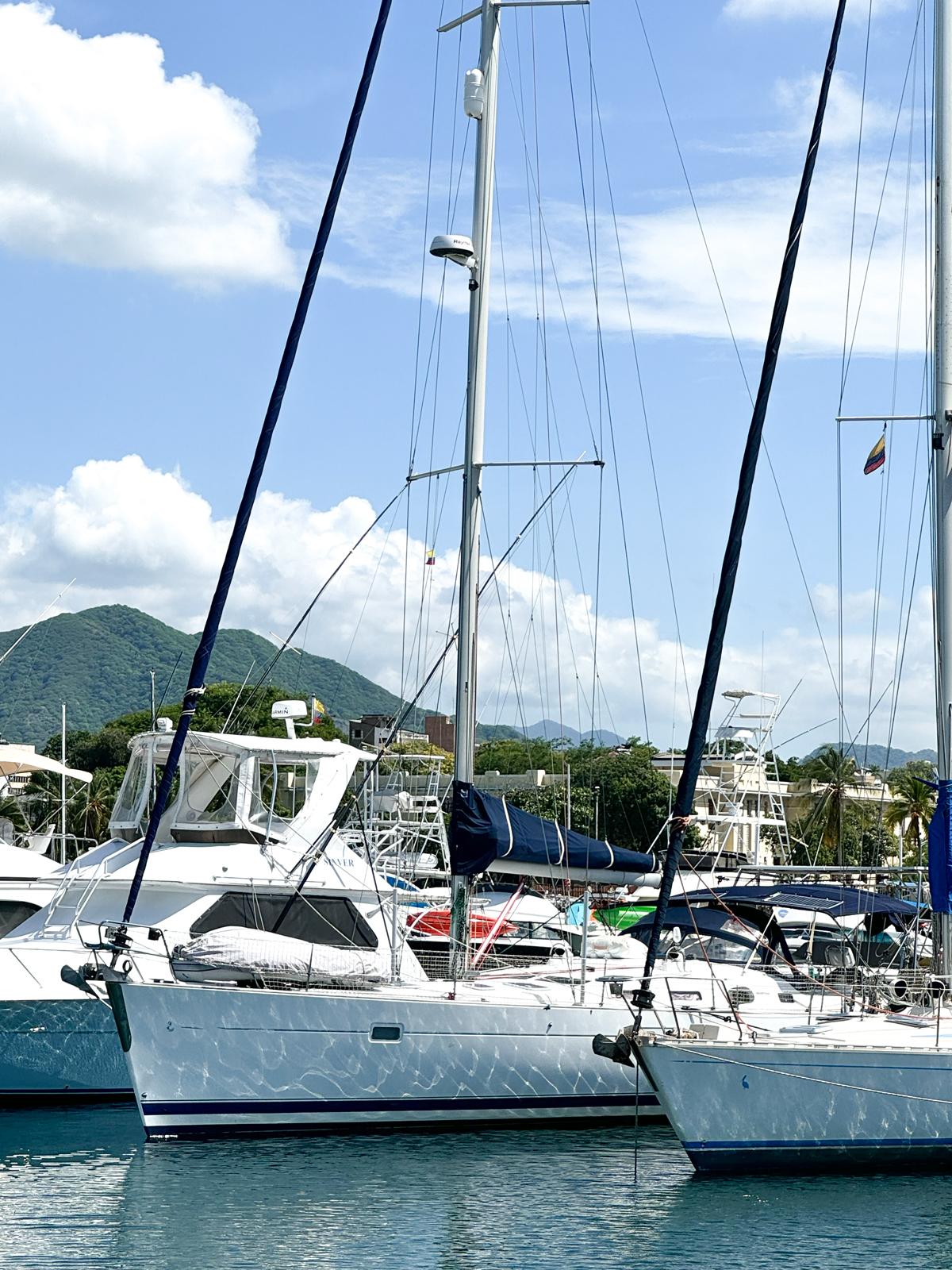 2006 Beneteau Oceanis 473 sailboat docked in a scenic marina.