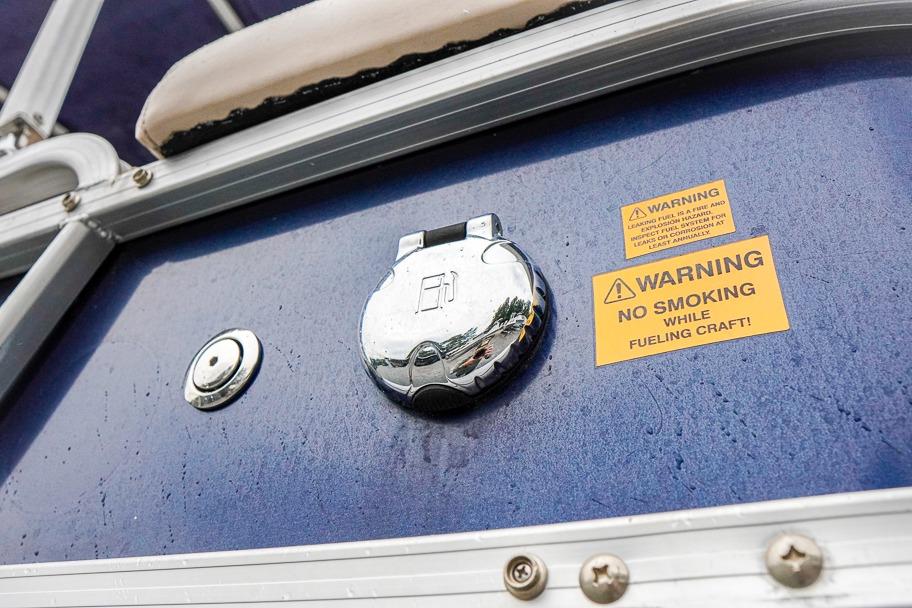 2012 Xcursion X21C boat fuel cap with safety warning labels.