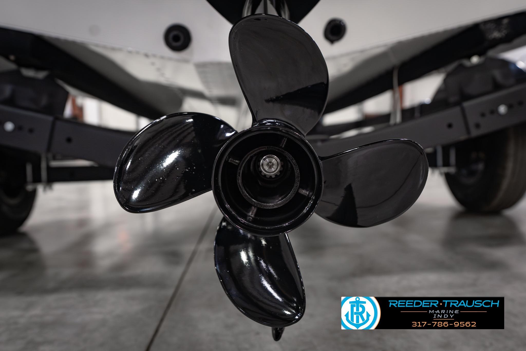 Close-up of a 2026 Lund 1650 Rebel XL SS boat propeller in a showroom.