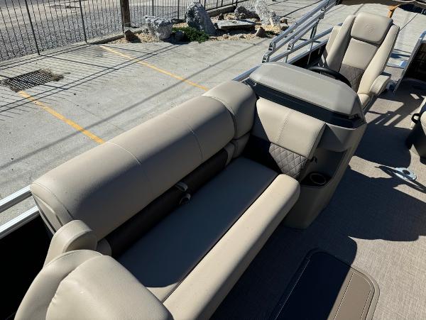 2025 Sun Tracker 24 Sportfish XP3 boat interior with beige seating and cup holders.