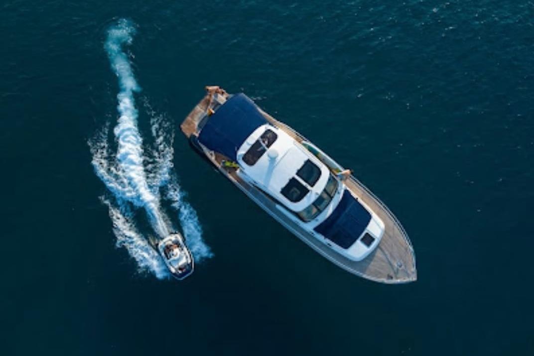 Aerial view of 2009 Franchini Emozione yacht with a jet ski nearby on the ocean.