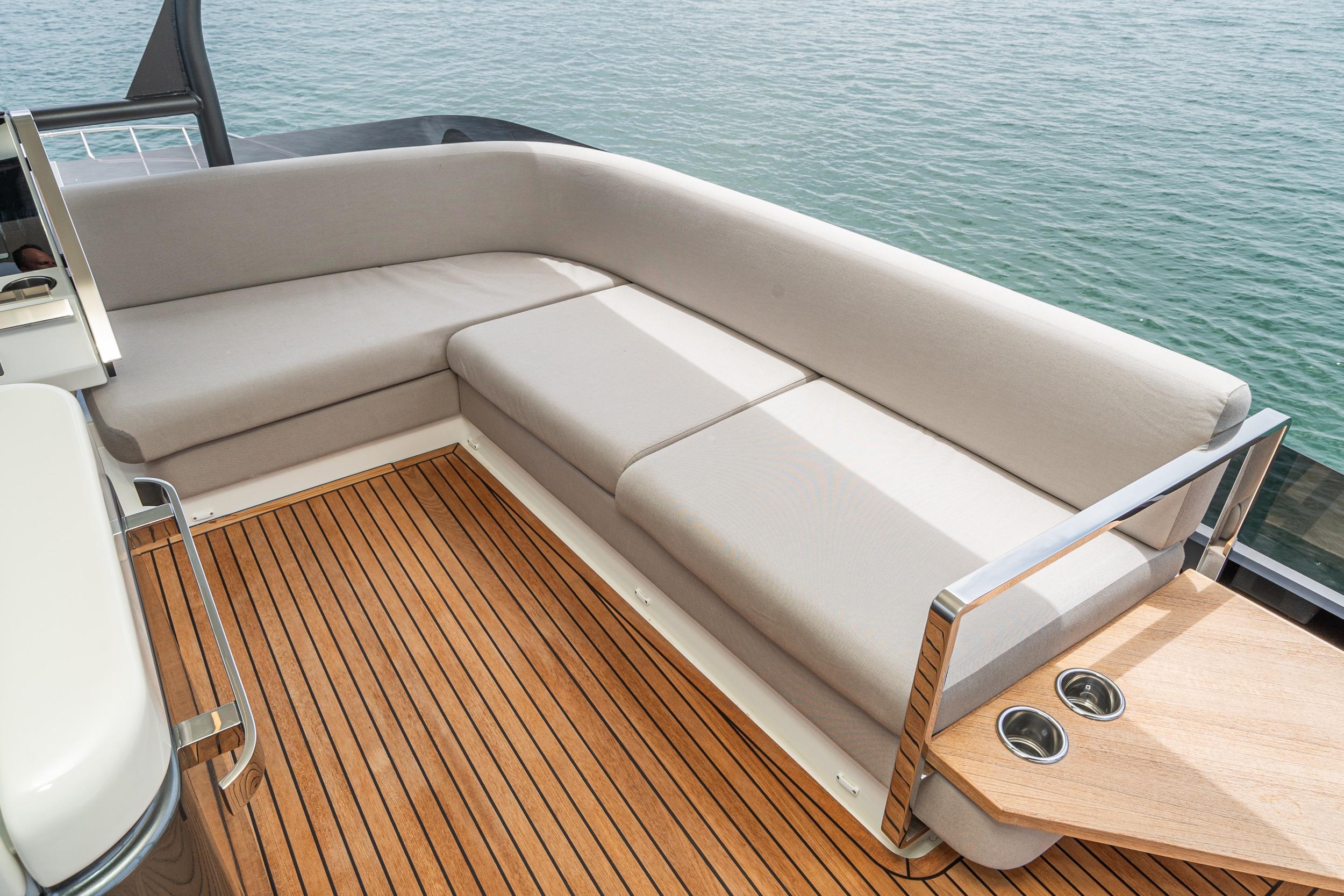 Luxurious seating area on 2024 Prestige X60 yacht with elegant wooden deck.