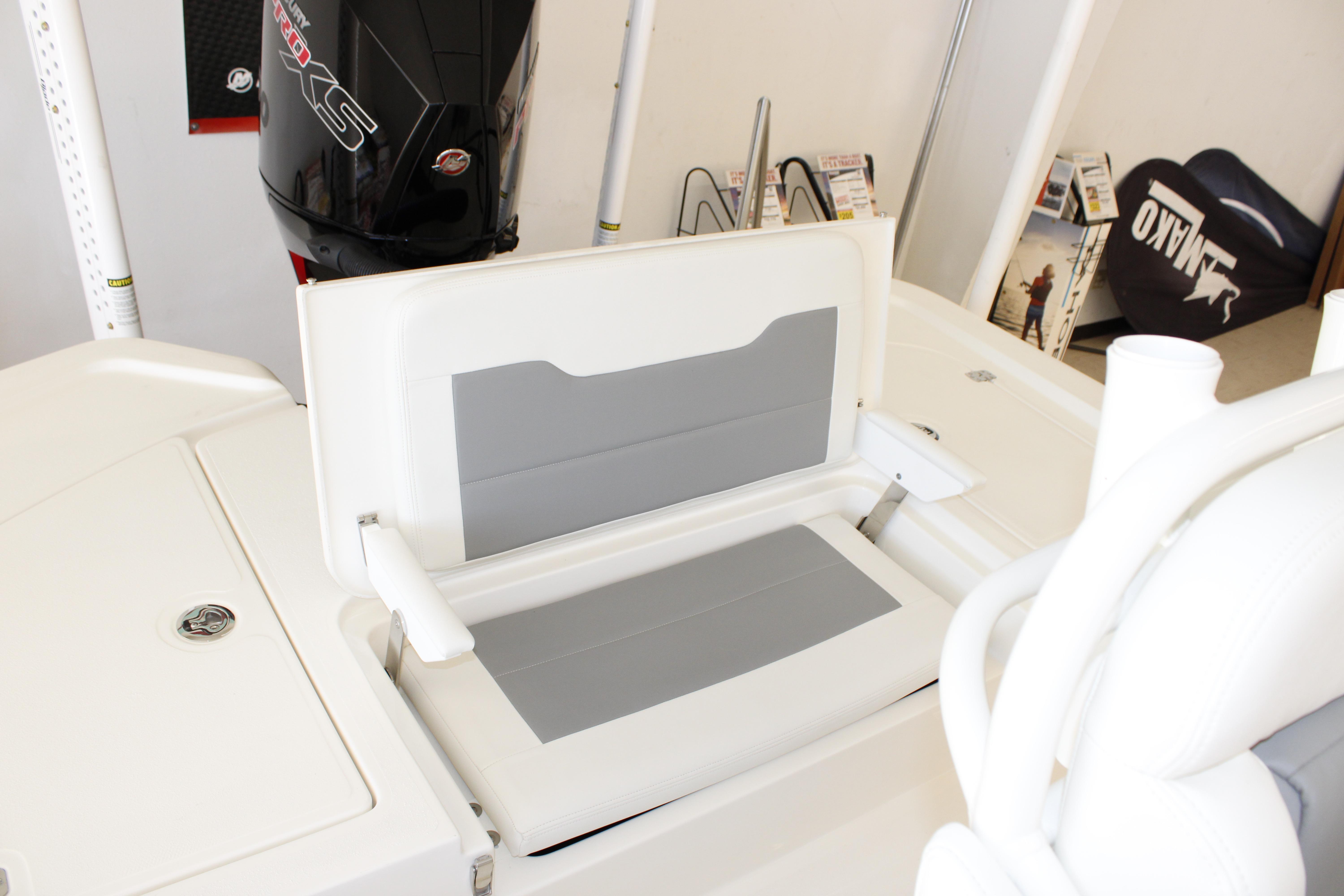 2026 Mako 24 APEX boat interior with cushioned seating and storage compartment.