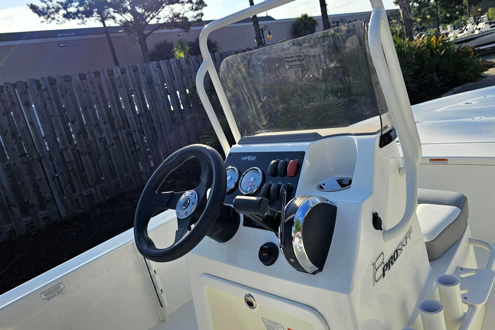 2026 Mako 18 Pro Skiff boat console with steering wheel and gauges.