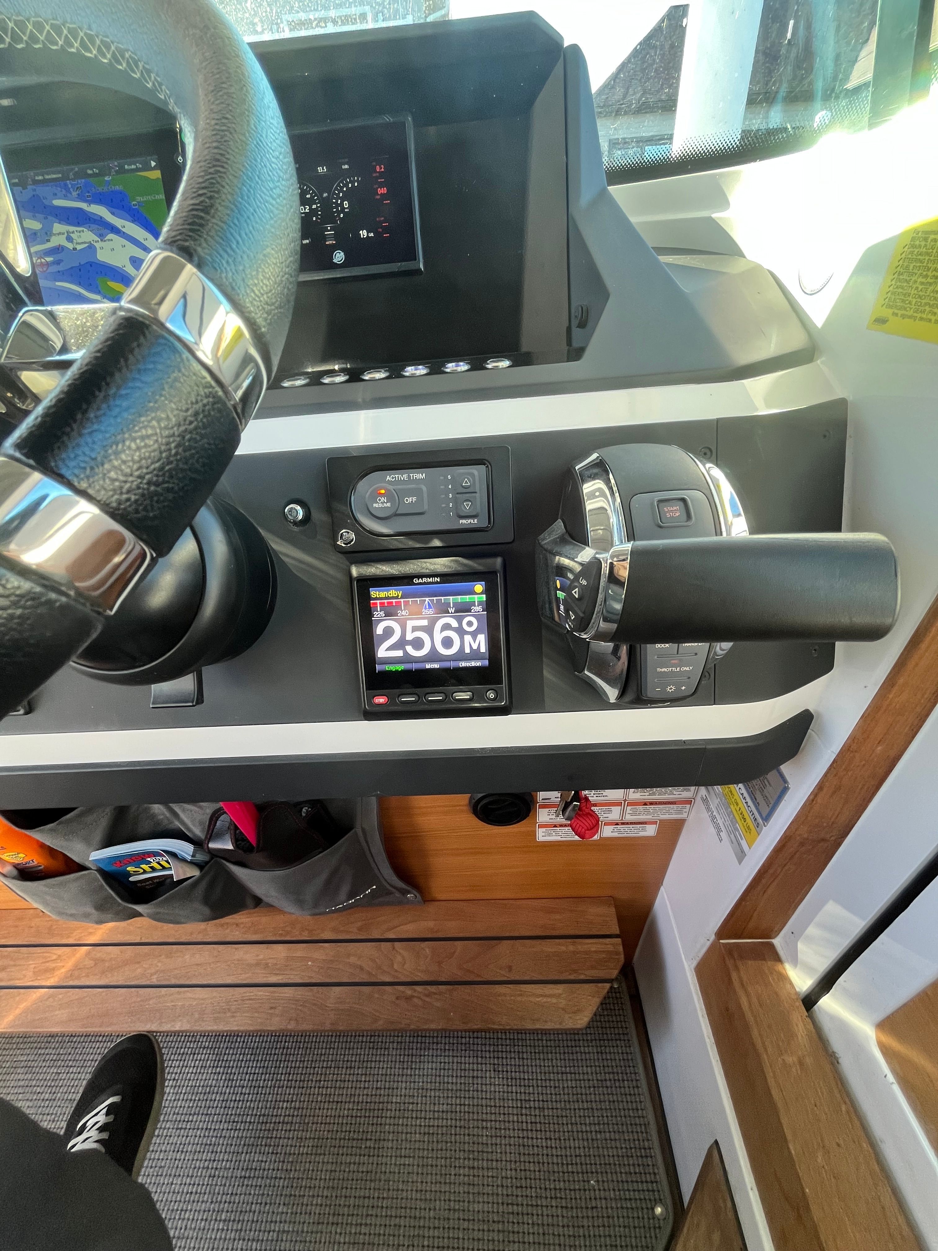 Helm of the Axopar 28 Cabin with modern instruments.