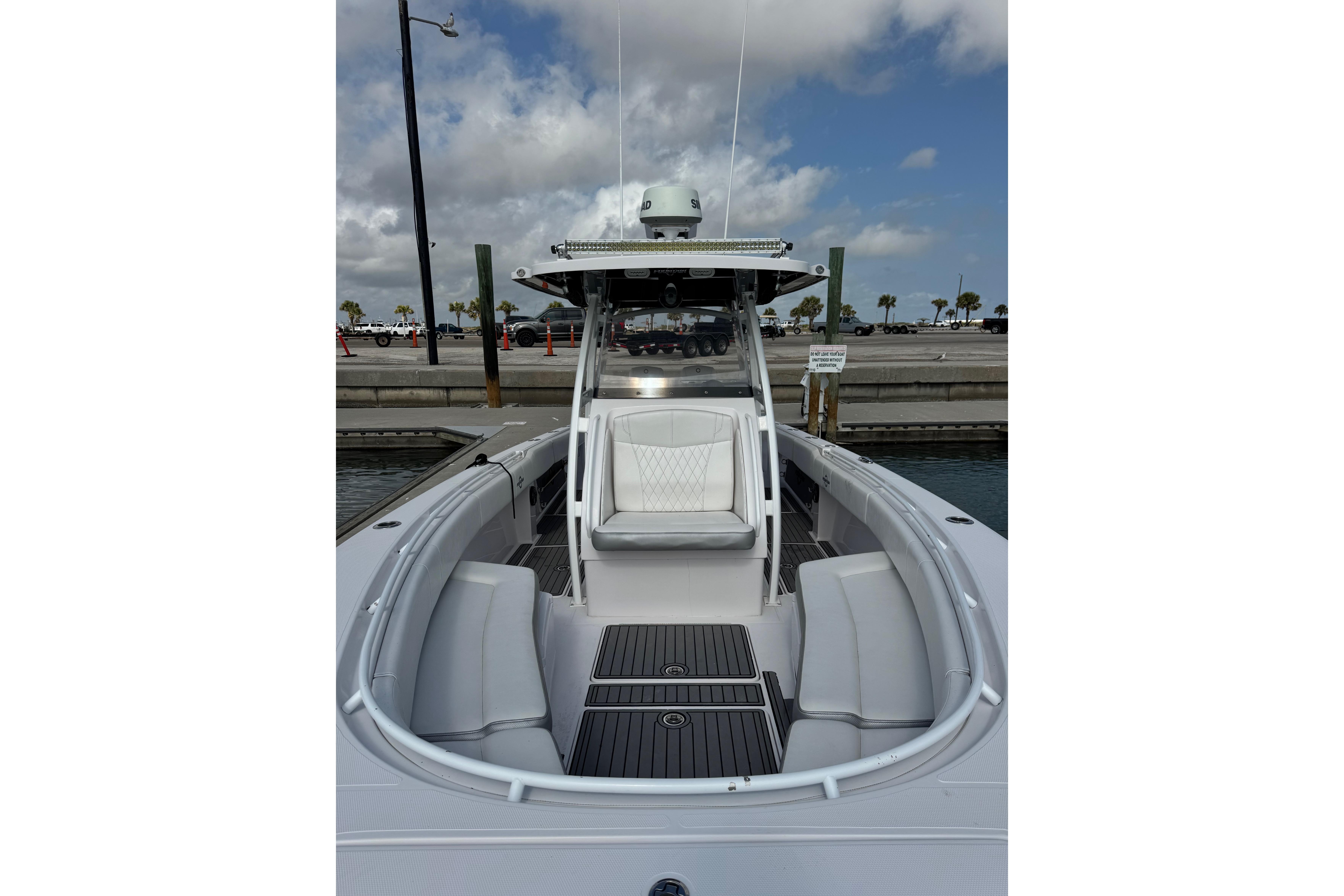 2018 Fountain 34 Center Console boat docked, featuring sleek seating and modern design.