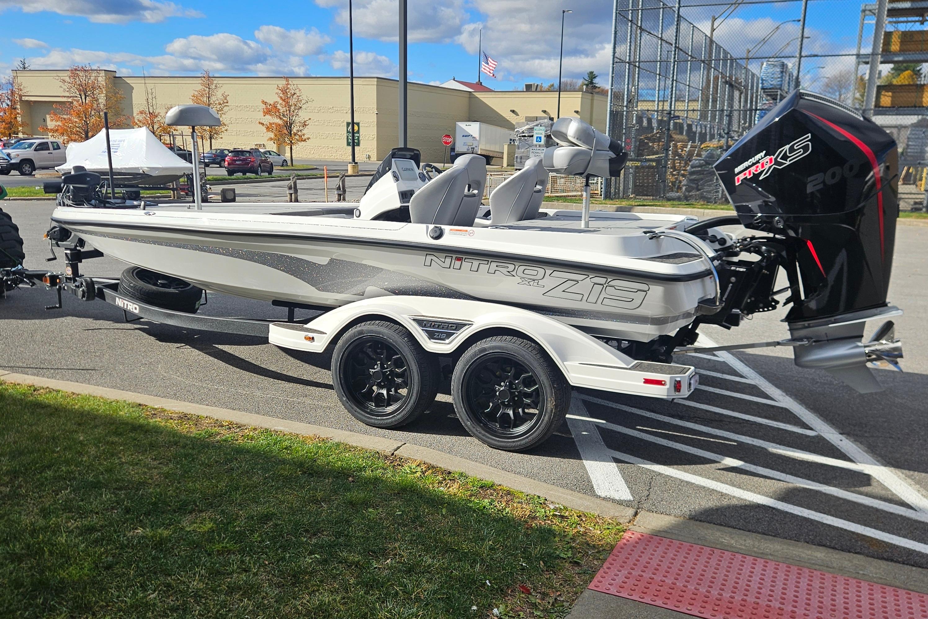 2026 Nitro Z19 XL Pro boat on trailer, parked outdoors under a blue sky.