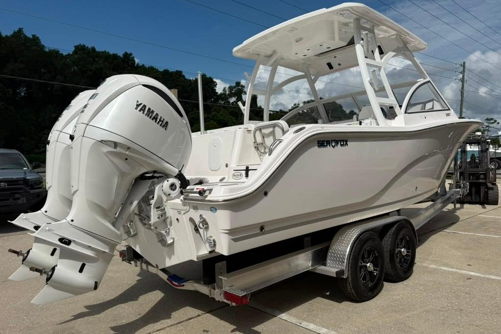 2026 Sea Fox 288 Traveler boat with Yamaha engines on a trailer, parked outdoors.