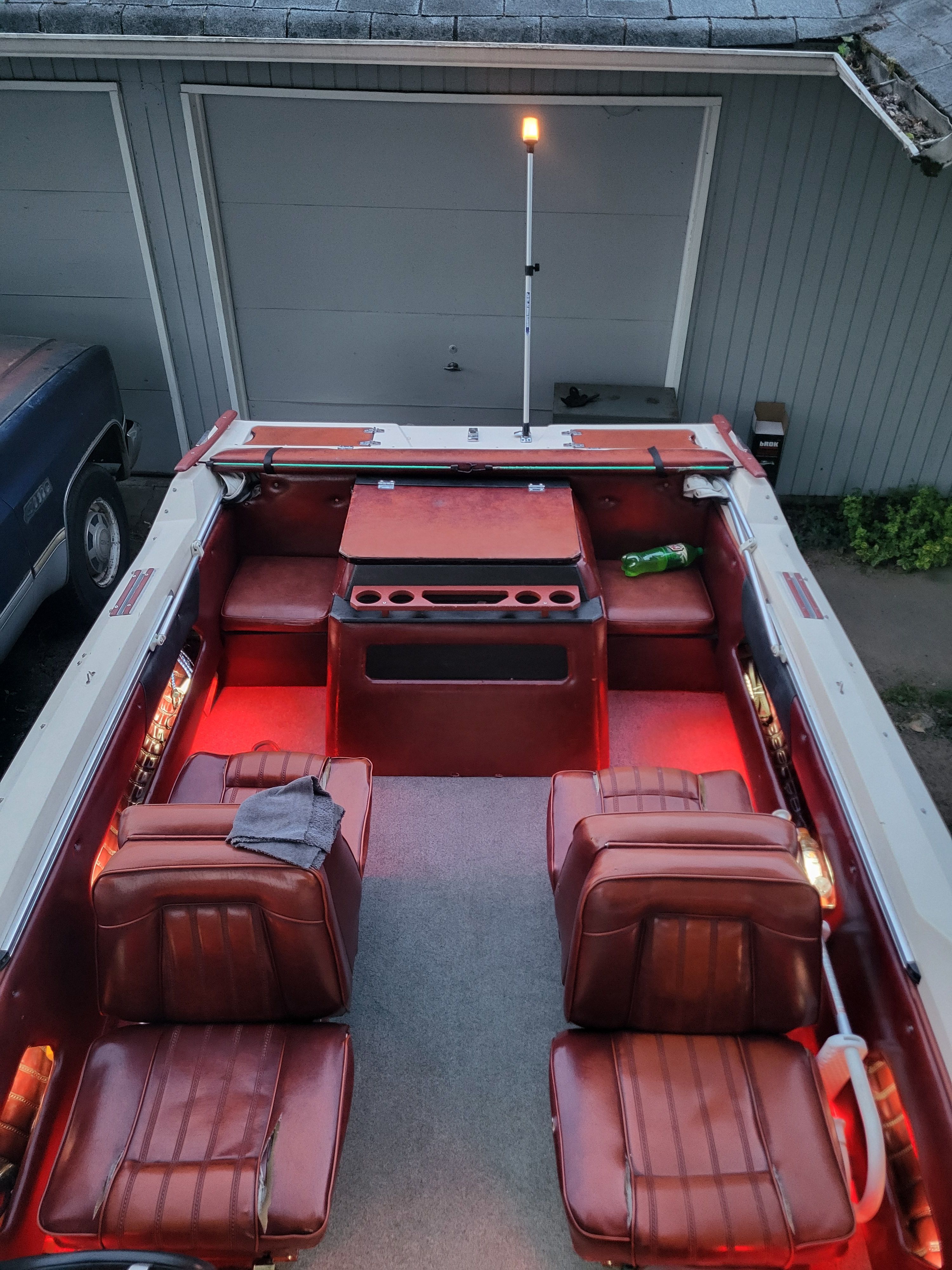 Interior of a 1977 Bayliner Jamaica boat with red lighting.