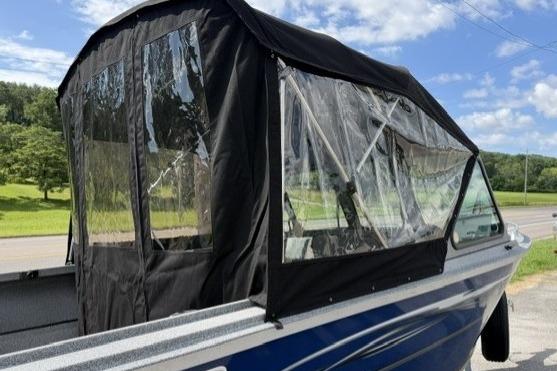 2023 Alumaweld Talon 18 boat with canopy, parked outdoors on a sunny day.